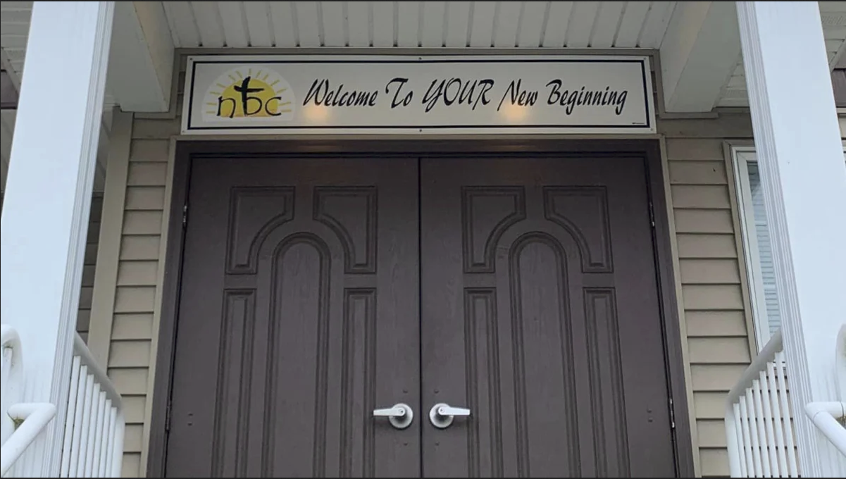 Double door entrance with a sign above that reads, "Welcome To YOUR New Beginning."