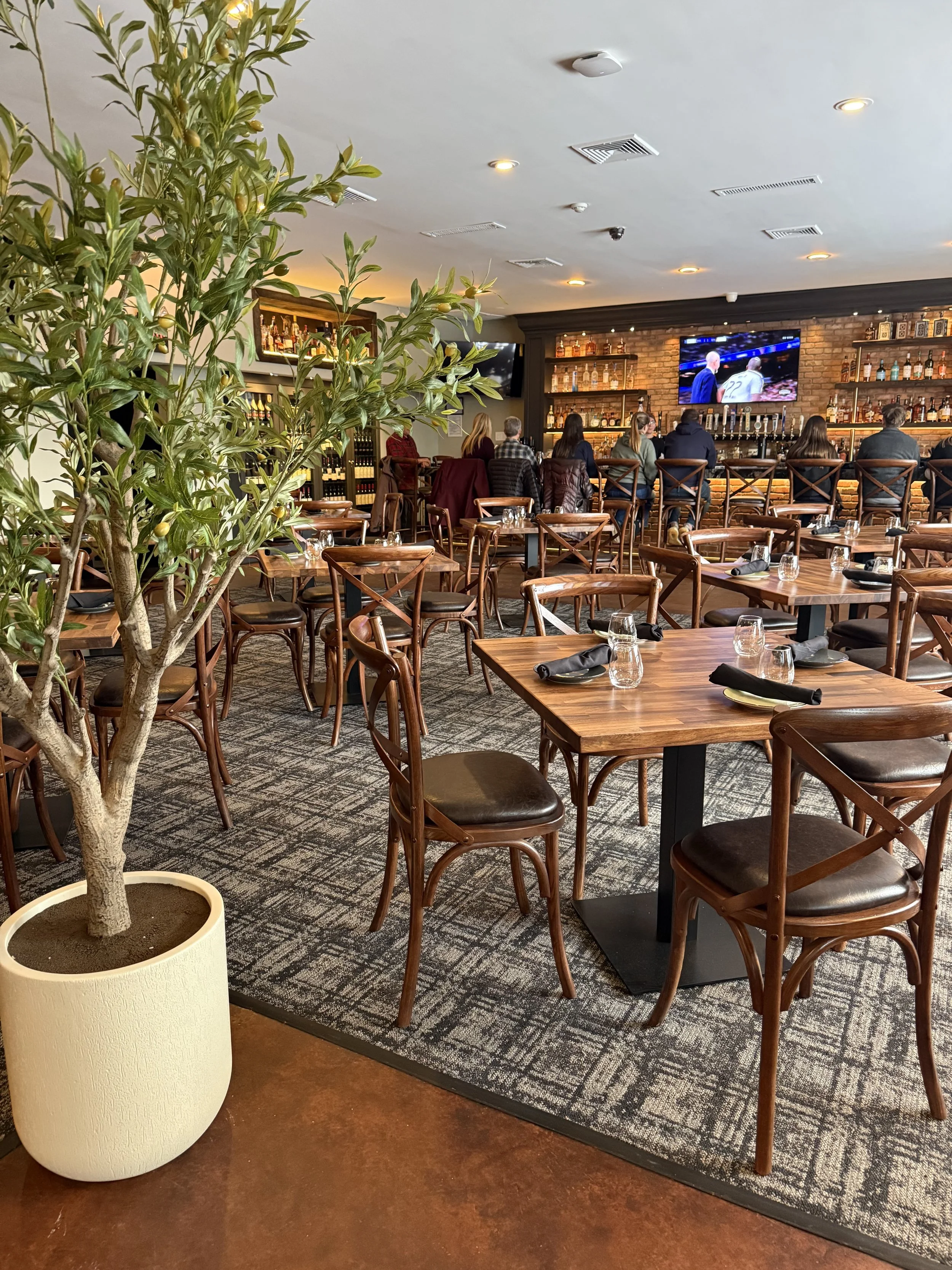 Main dining room at Duo Restaurant & Bar in Haddon Township, NJ – modern-rustic ambiance with dark sophisticated colors, warm lighting, and cozy seating