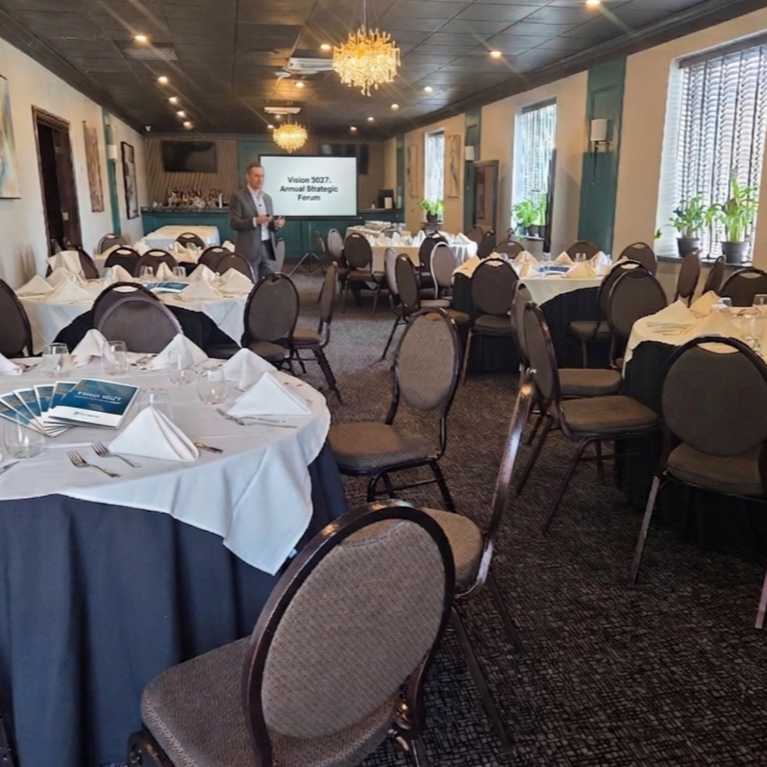 Our Fountain Room set up for a business luncheon with a projector