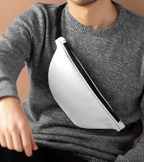 Person wearing a gray sweater with a white crossbody bag.