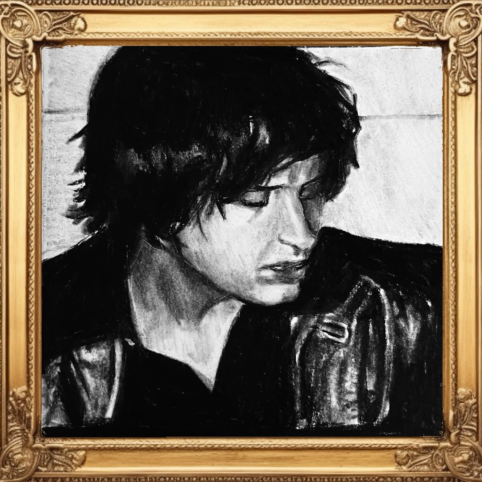Old black and white photograph of a woman with curly hair, framed in an ornate gold picture frame.
