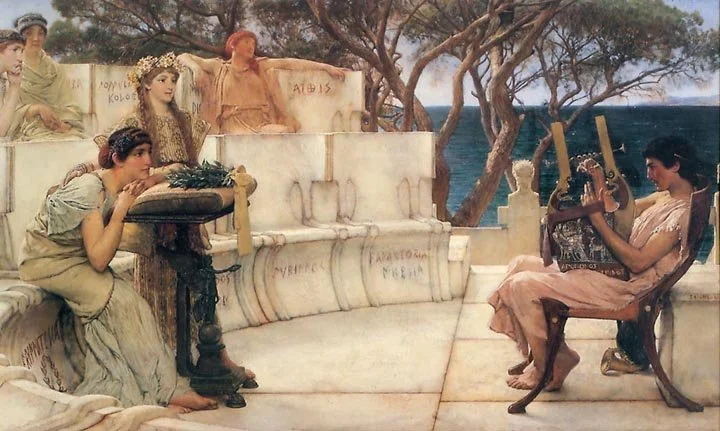 A woman playing a guitar and a woman resting her head on her arms on a stone bench, with three women sitting behind, in an outdoor scene near the sea with trees.