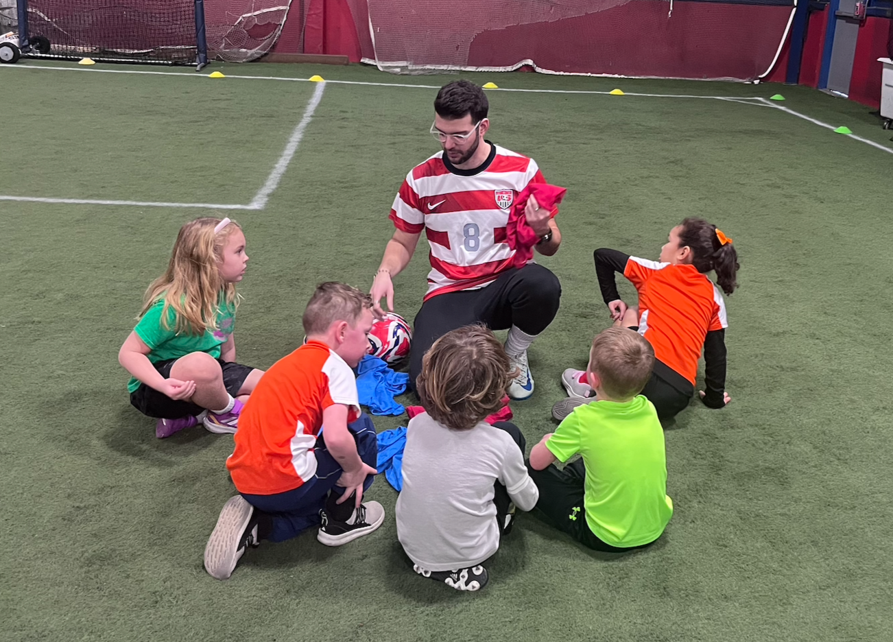 Coach is surrounded by his u6 students