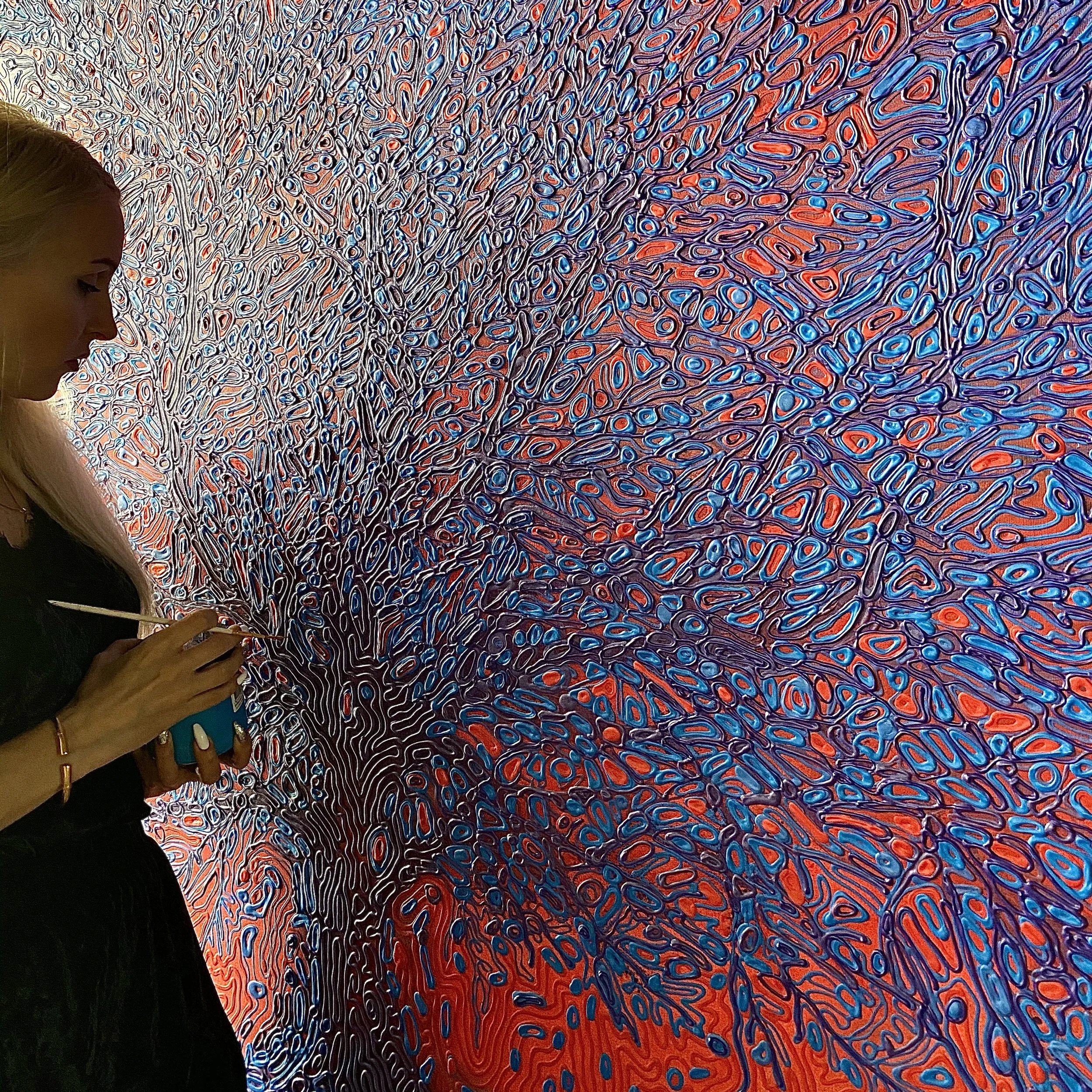 Iryna Sushelnytska working across a large-scale painted surface using