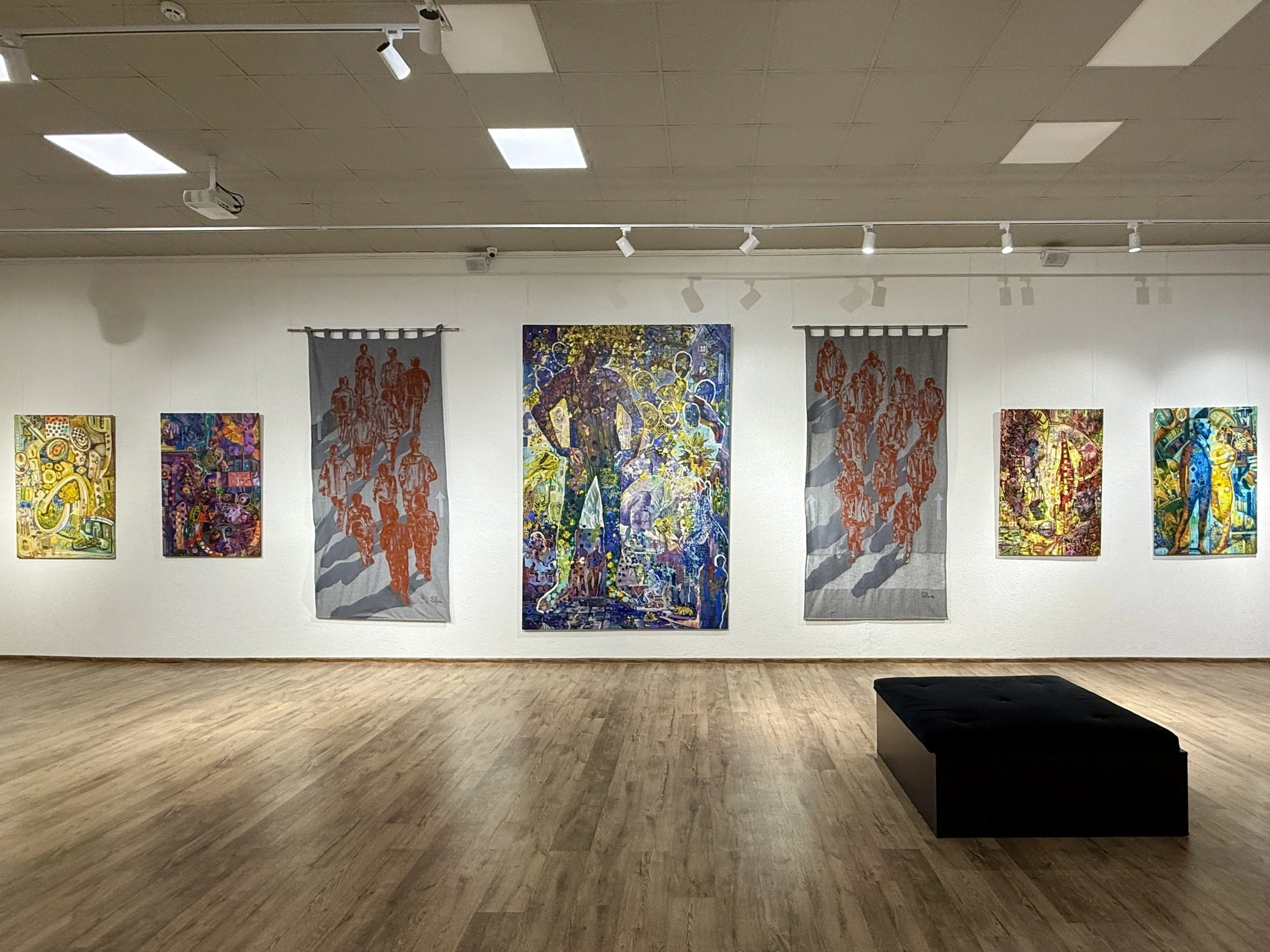 Exhibition view showing painting and textile works by Iryna Sushelnytska within a single project-based artistic practice.