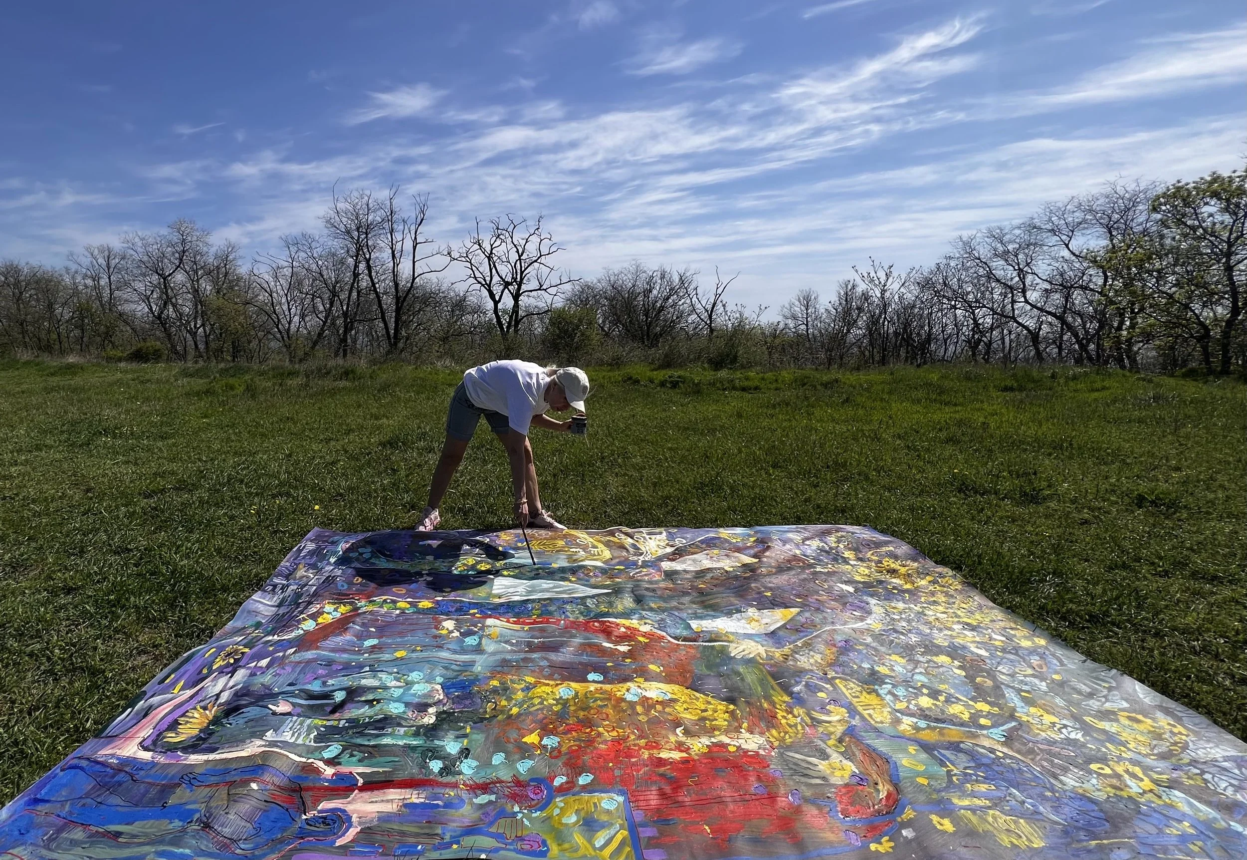 Iryna Sushelnytska working across a large-scale painted surface using full-body movement