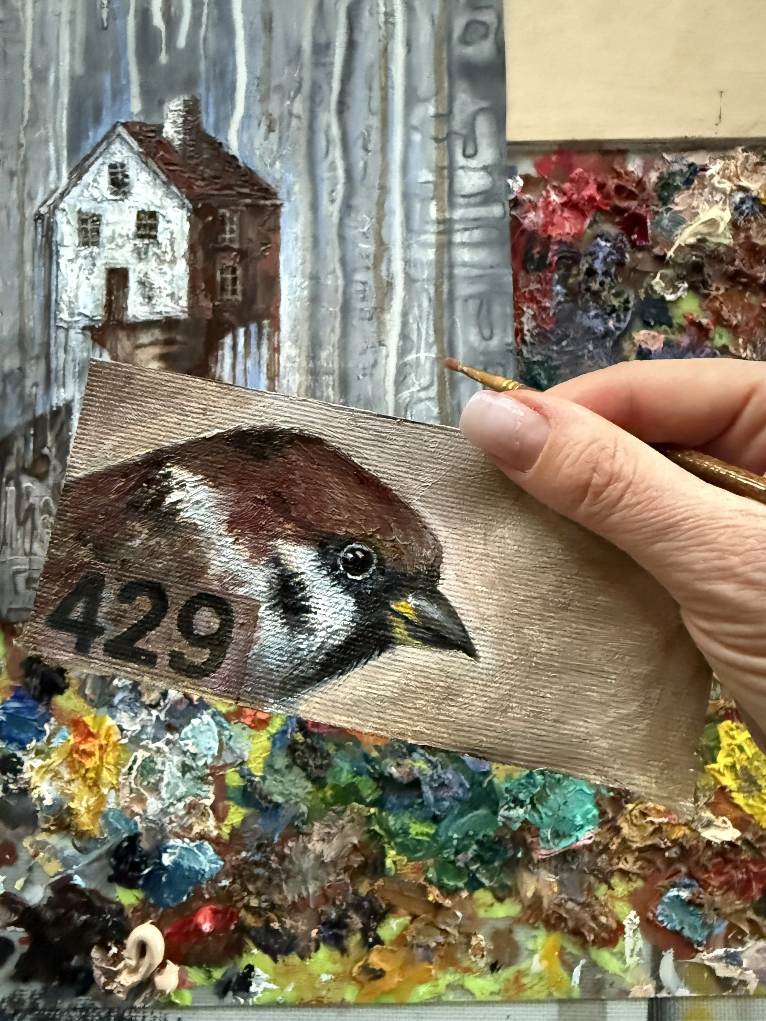 Small-scale artwork held in the artist’s hand, showing the relationship between form and human scale