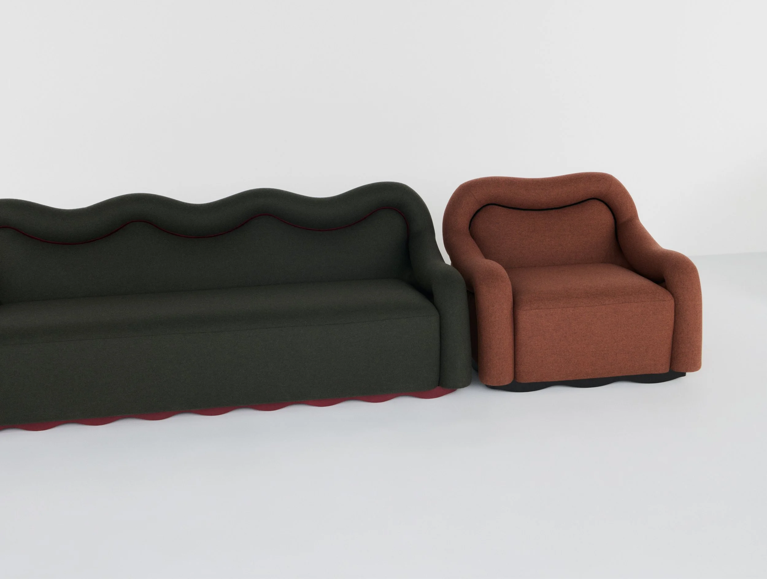 Canapé sombre au dossier ondulé et fauteuil brun aux formes arrondies de la collection Atlas of Desire.