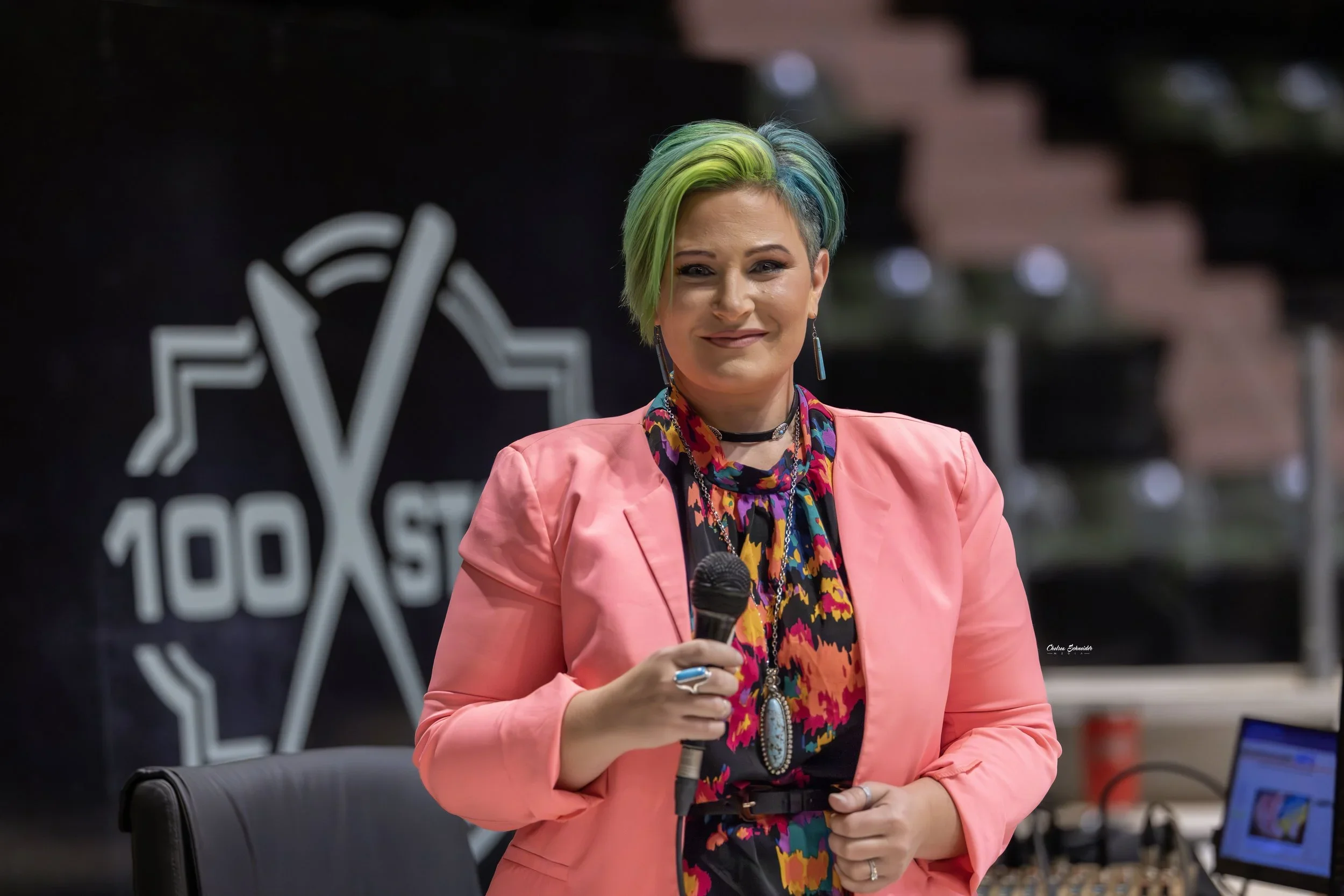 Chelsea Sutton holding a microphone looking amazing.