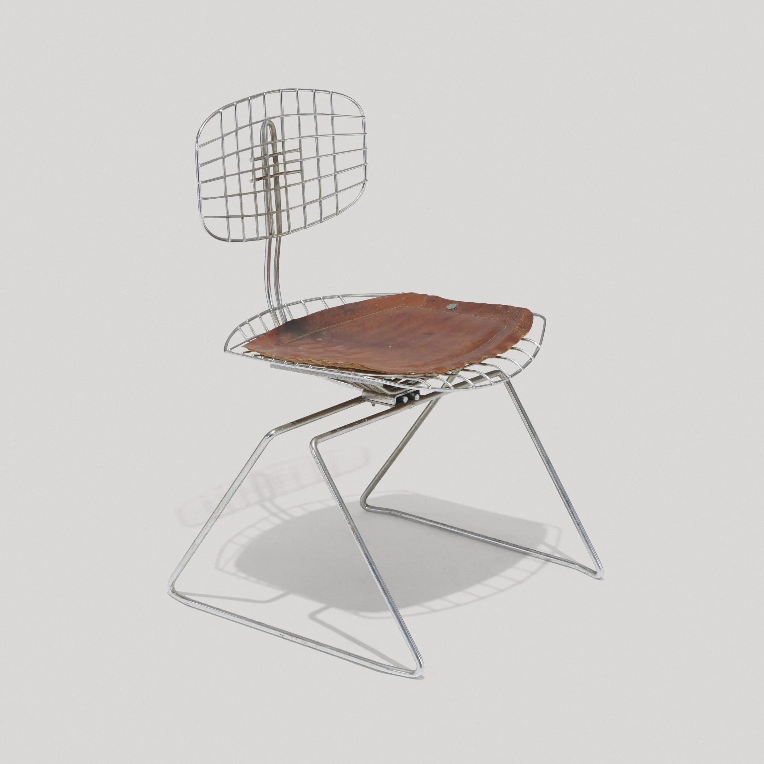 A metal chair with a wire backrest and seat, featuring a wooden pad on the seat against a plain white background.