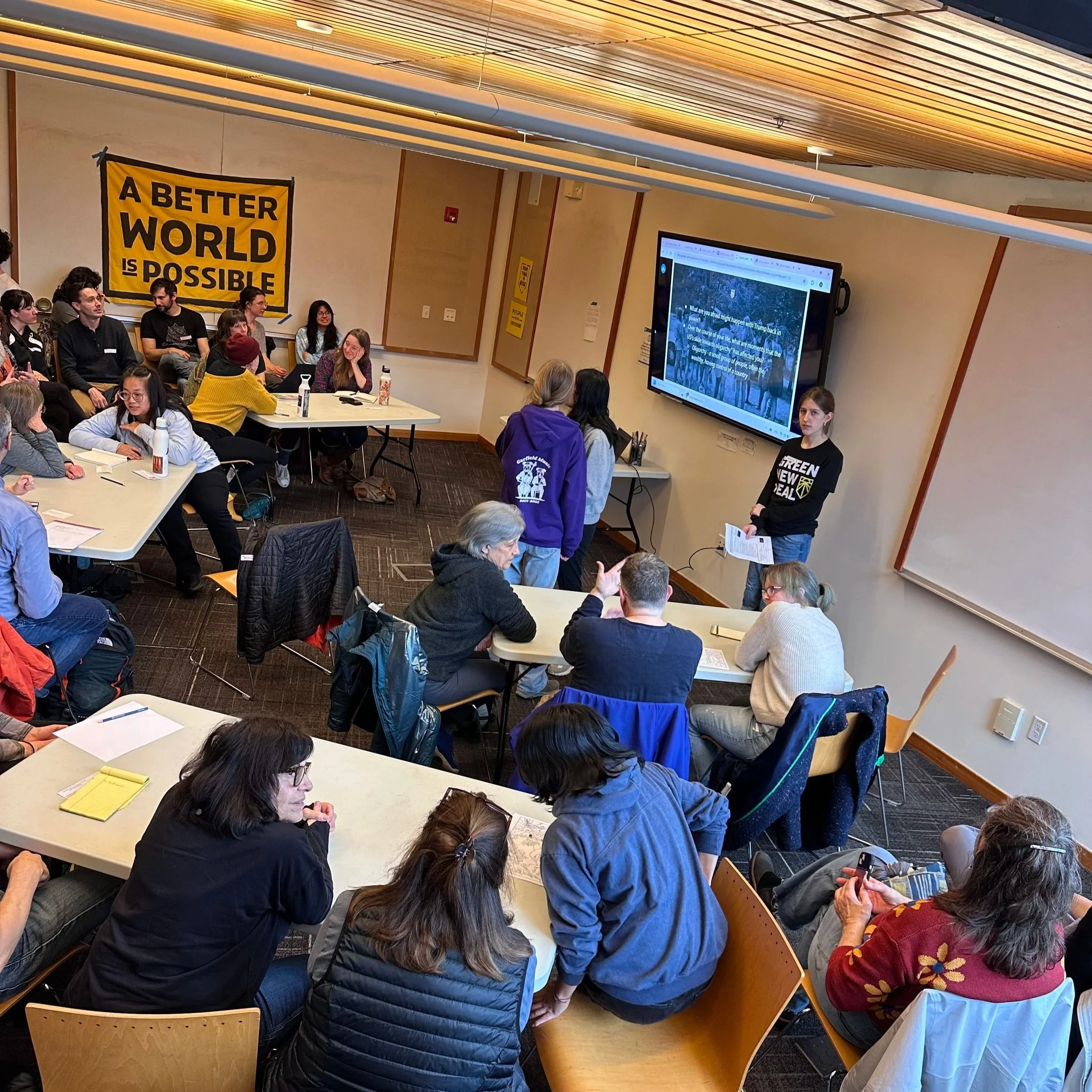 Sunrise leaders teach members of the community about ways to end an Oligarchy