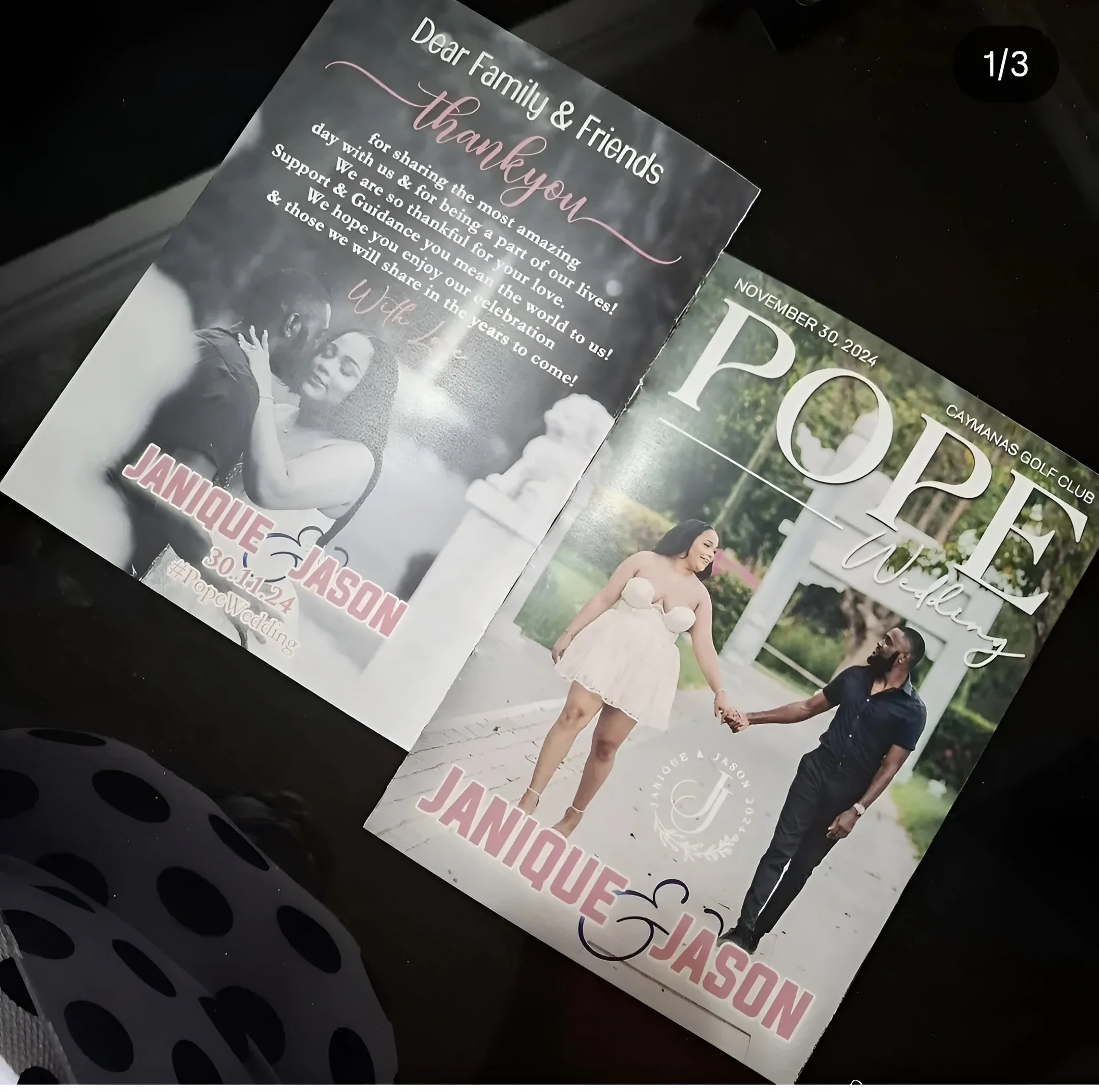 A wedding announcement card featuring a couple holding hands on a park trail, with the woman wearing a light-colored strapless dress and the man in a dark shirt and pants. The card includes text with the couple's names, Janiqué and Jason, and details