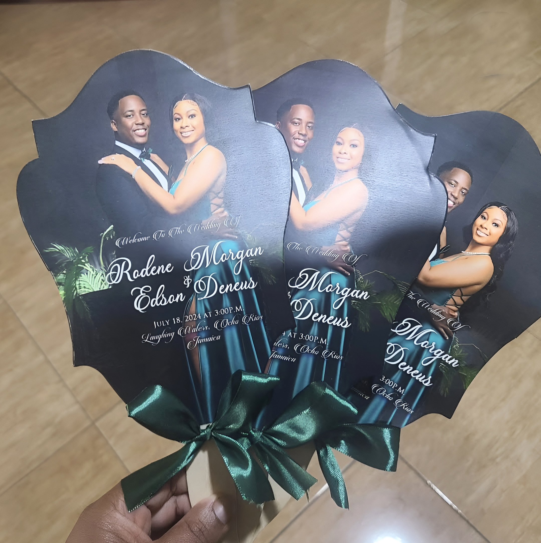 Celebration fans with a romantic photo of a couple dressed in formal attire, with text celebrating their wedding on July 18, 2024, at 3:00 p.m. at Laughing Waters, Ocho Rios, Jamaica.