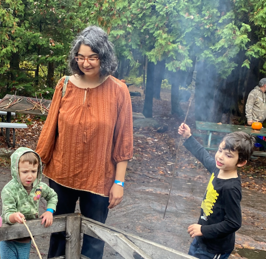 Masha Overseeing an activity at a campfire