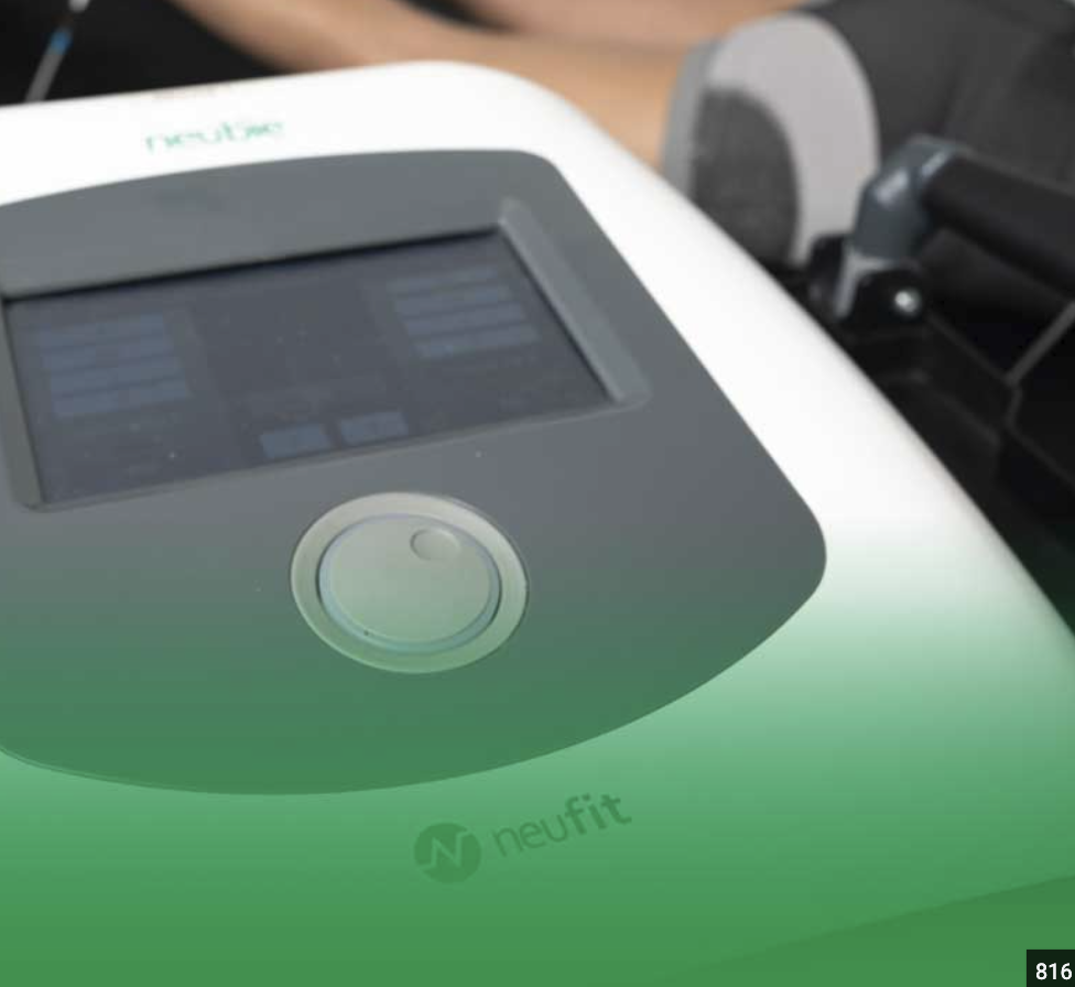 Close-up of a Neubie electrical stimulation device being used during a personal training session for neuromuscular recovery and performance