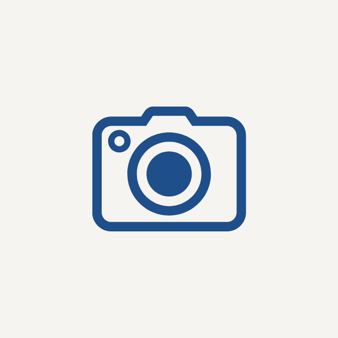 Icon of a camera in dark blue on a light gray background.