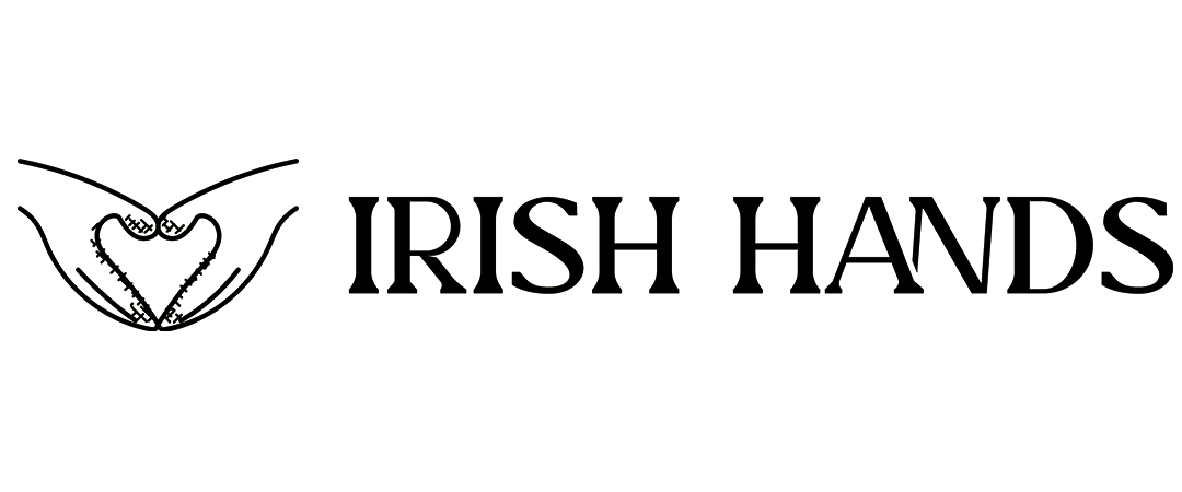 Logo of Irish Hands featuring two hands holding a shamrock.