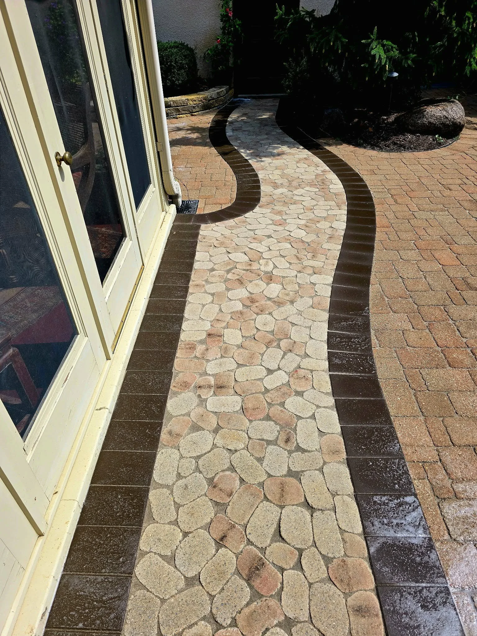 curved paver walkway with decorative rock border landscaping patio