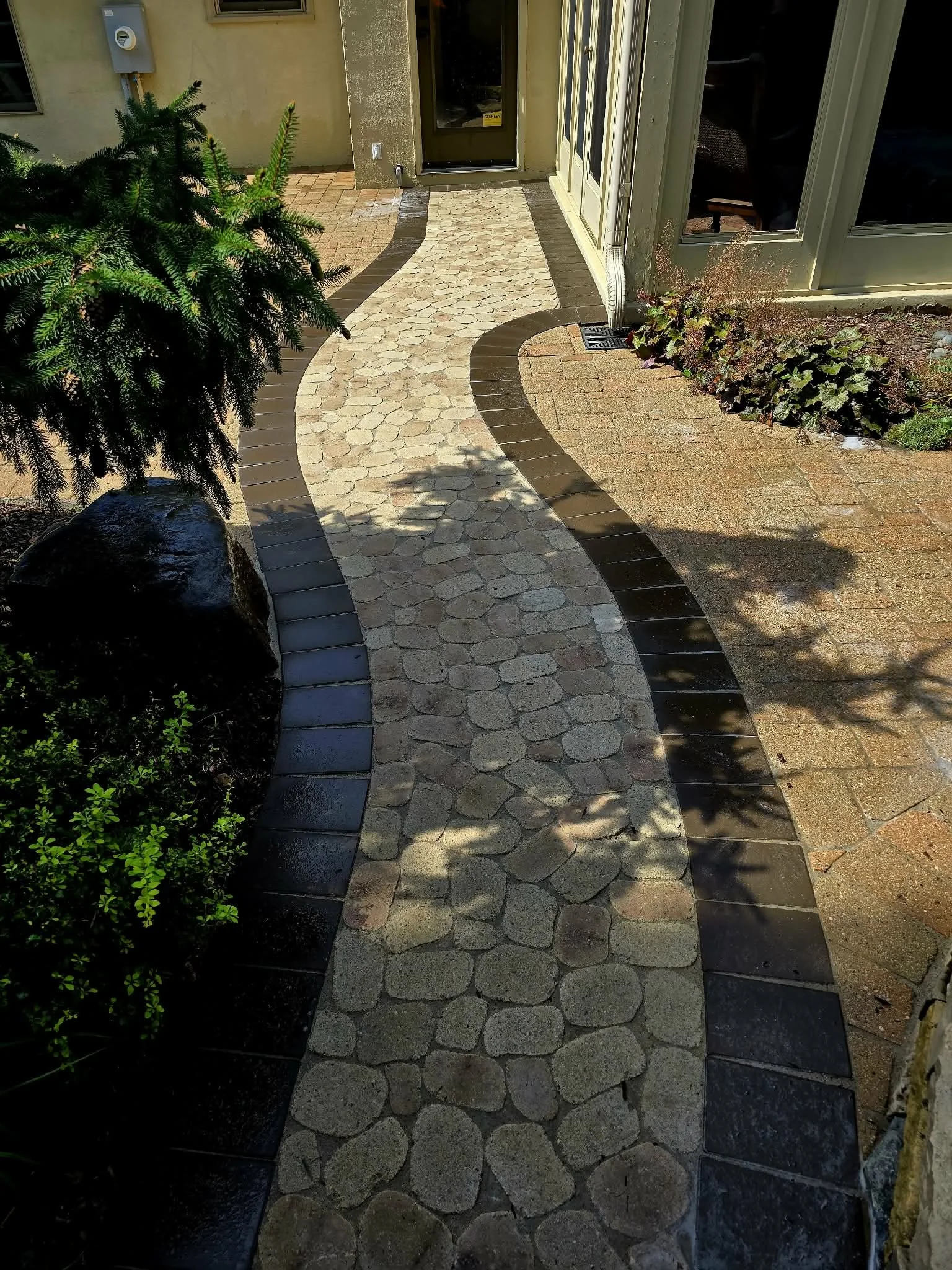 custom curved paver walkway leading to backyard residential Minnesota