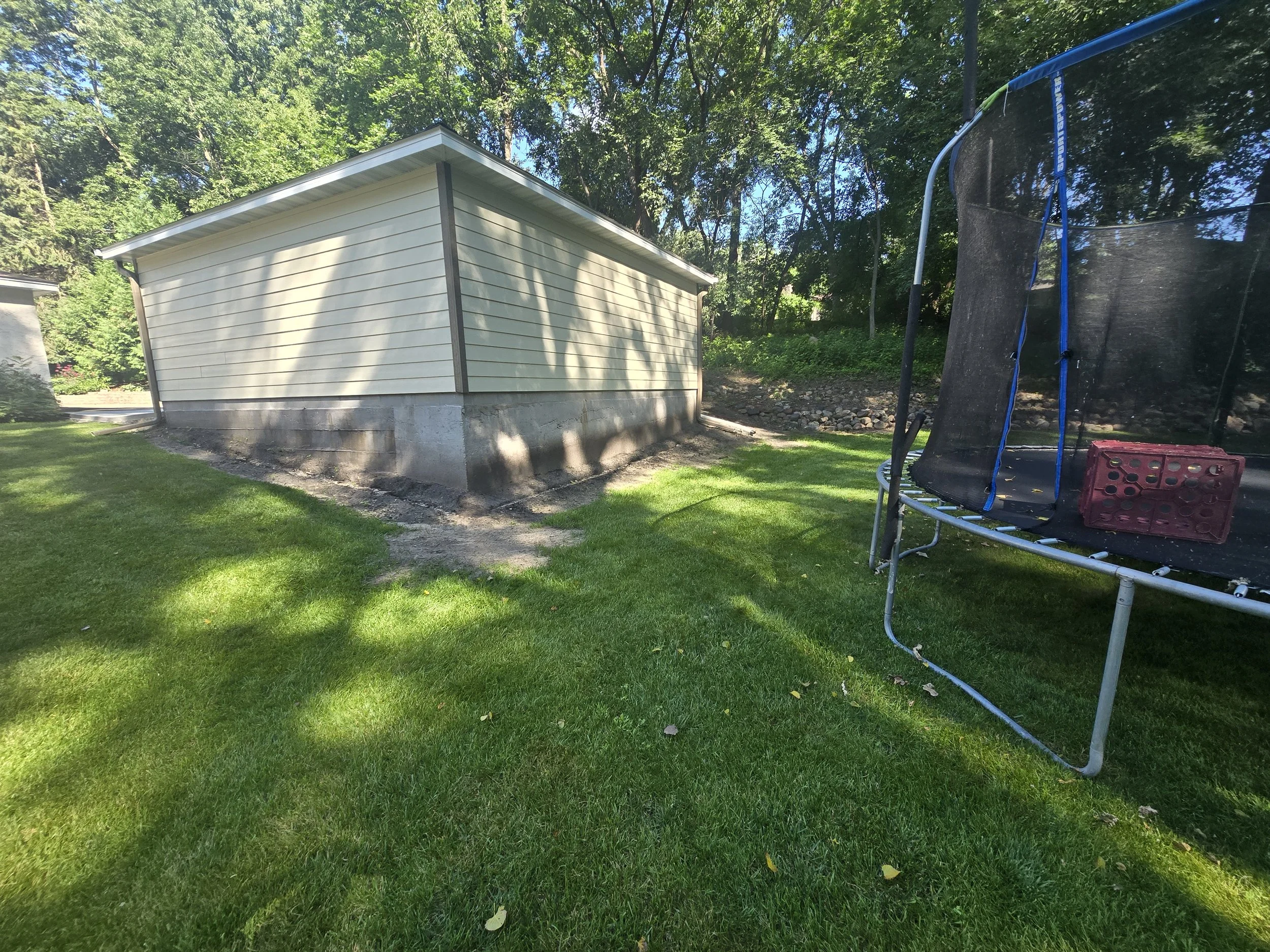 before retaining wall installation sloped backyard erosion issue Minnesota