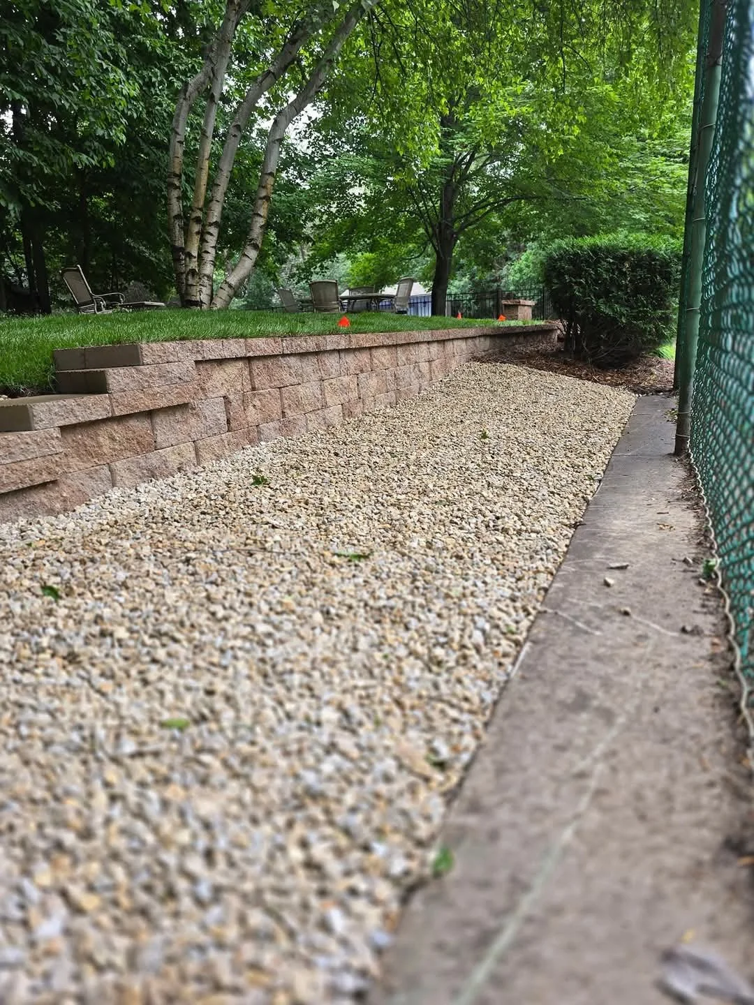 retaining wall installation with gravel drainage system residential Minnesota
