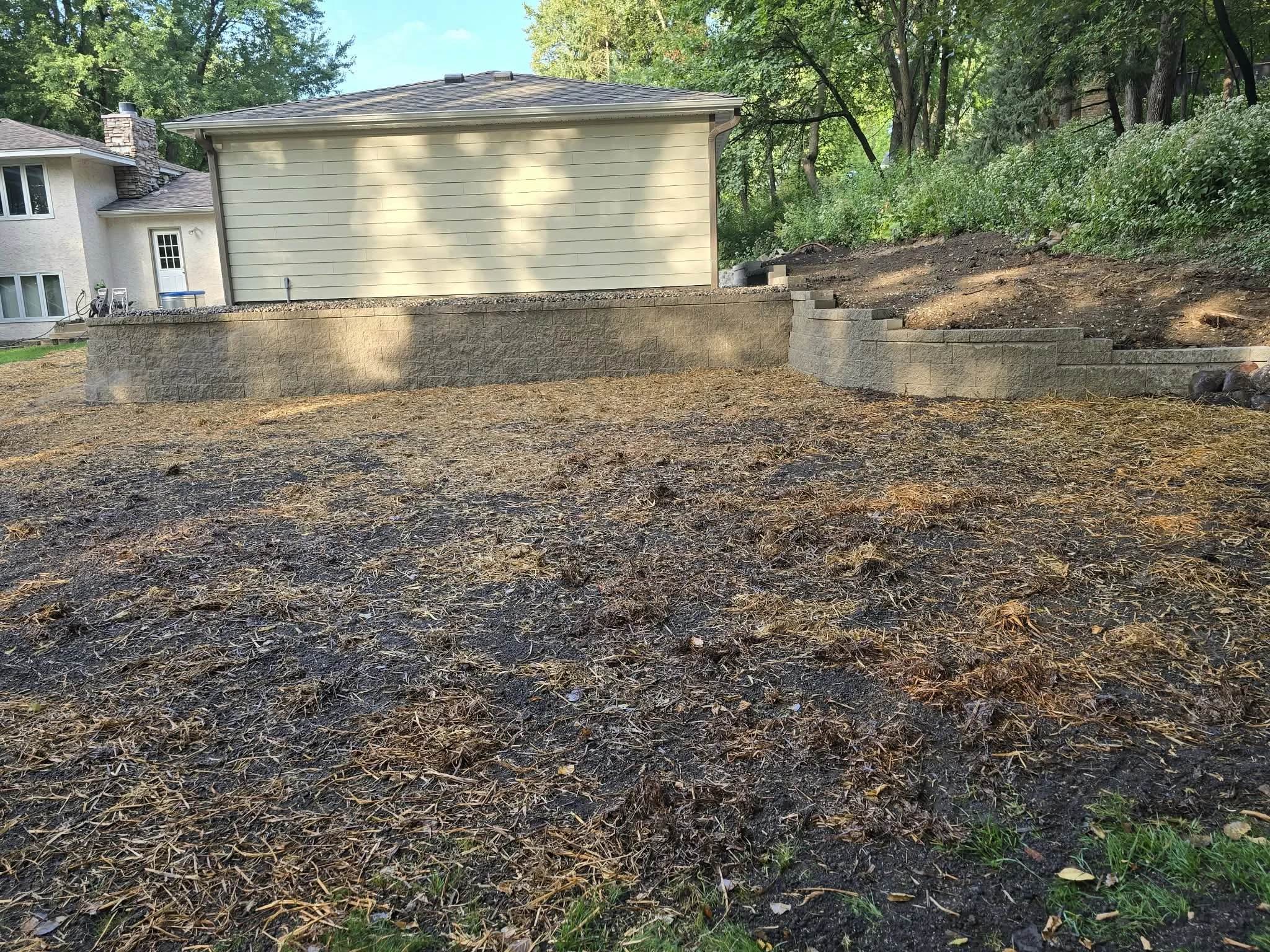 multi-level retaining wall system for sloped backyard