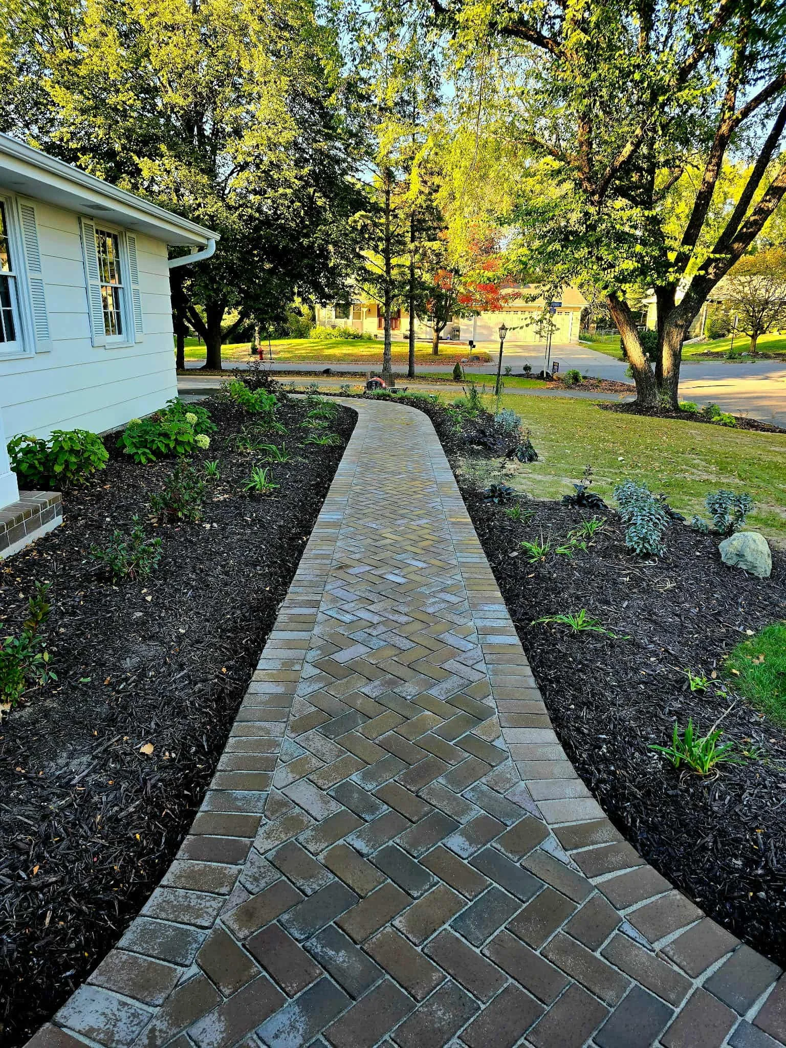 paver walkway installation with fresh landscaping and mulch
