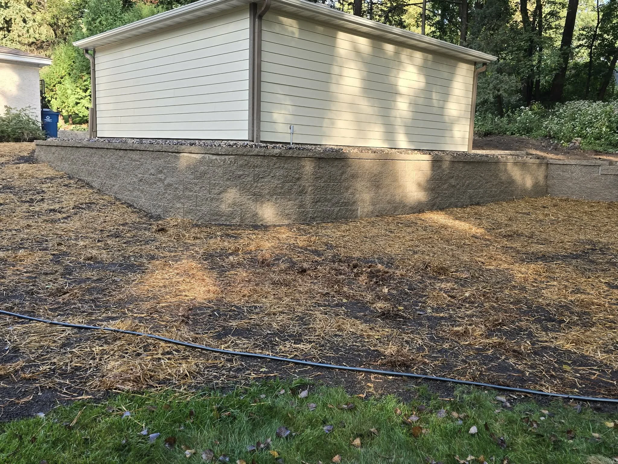 after retaining wall installation stabilizing slope near garage