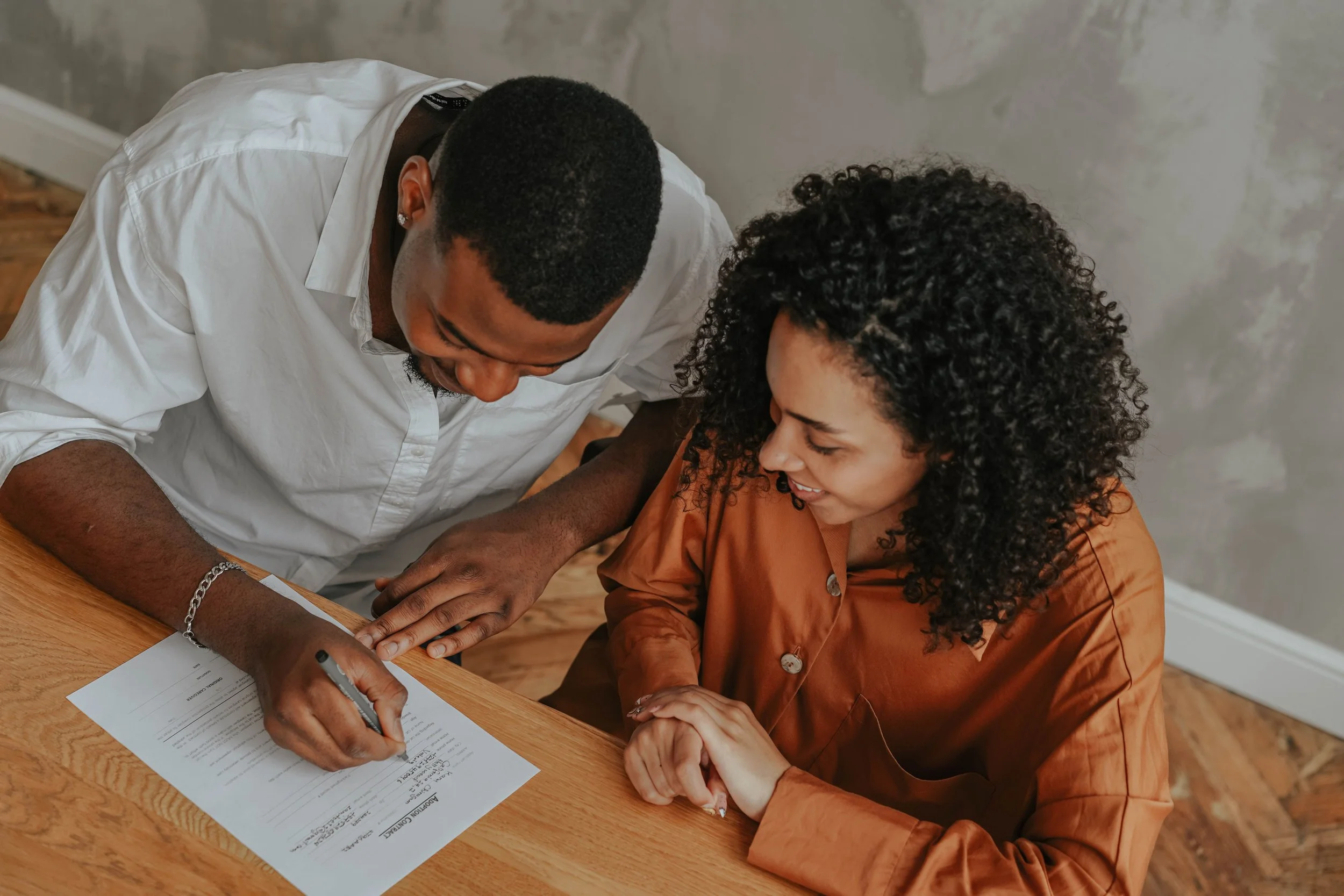 An attorney and client having a warm, relaxed consultation at a table