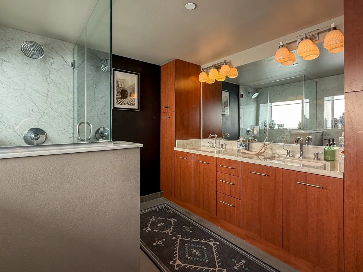 Primary bathroom with dual sinks. Walk-in shower. 