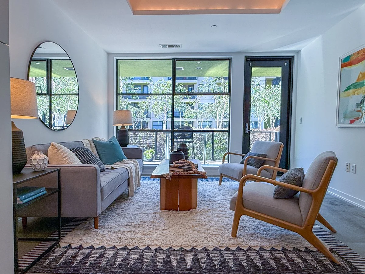 Living area with patio visible through window. 