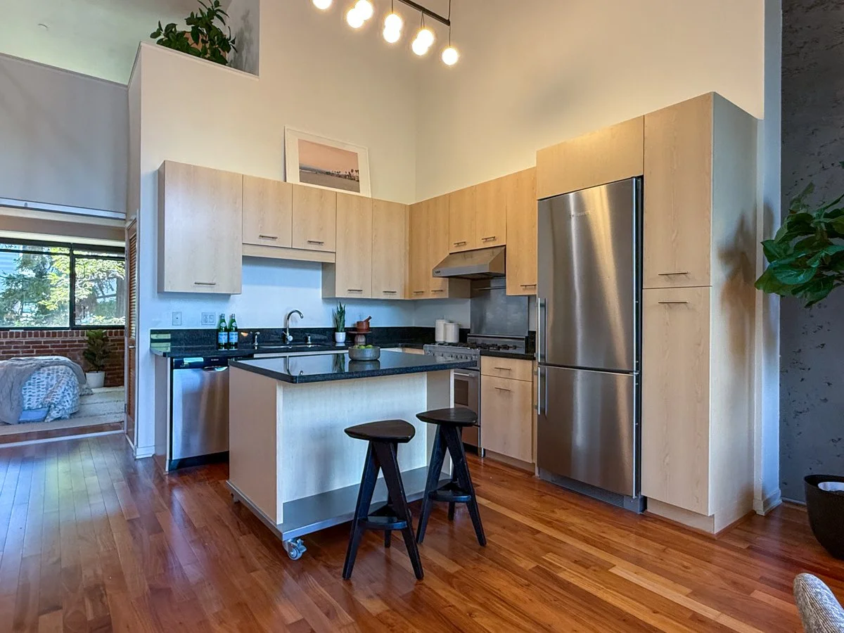 Modern kitchen with stainless steel appliances and granite counters.