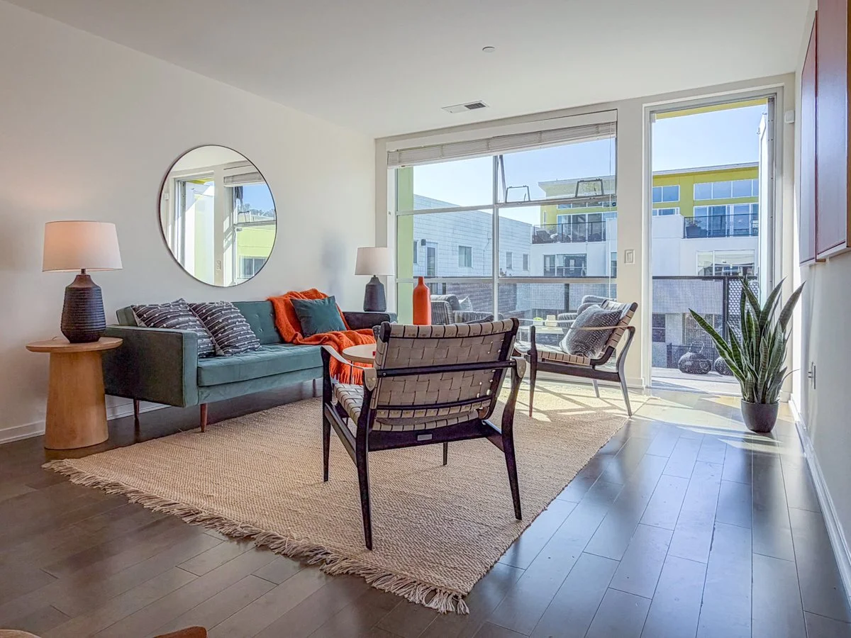 Living room and view to balcony and north court. 