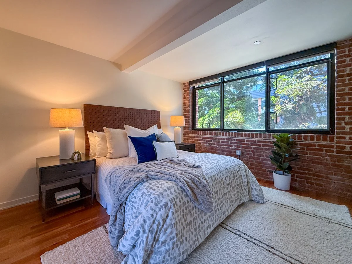 Downstairs bedroom has sliding panels for additional privacy. Views to mature redwood trees.