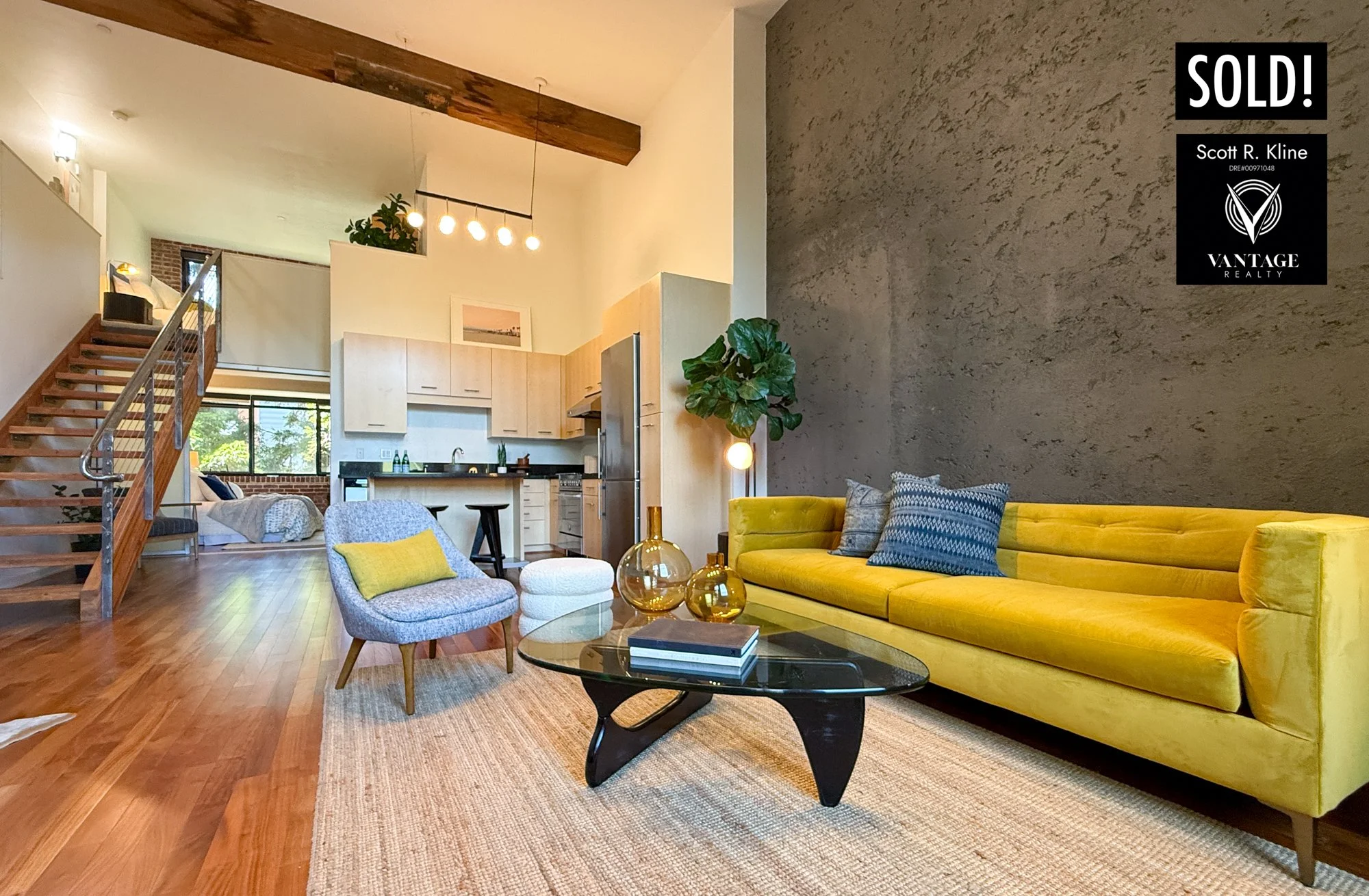 Loft Condominium with concrete wall, expose timber beams, wood floors and modern staircase. Graphic on photo says, SOLD!, Scott R. Kline, Vantage Realty