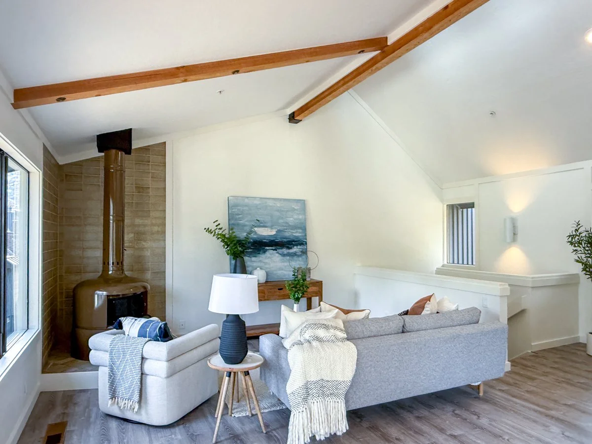 Upstairs living area with exposed beams. 