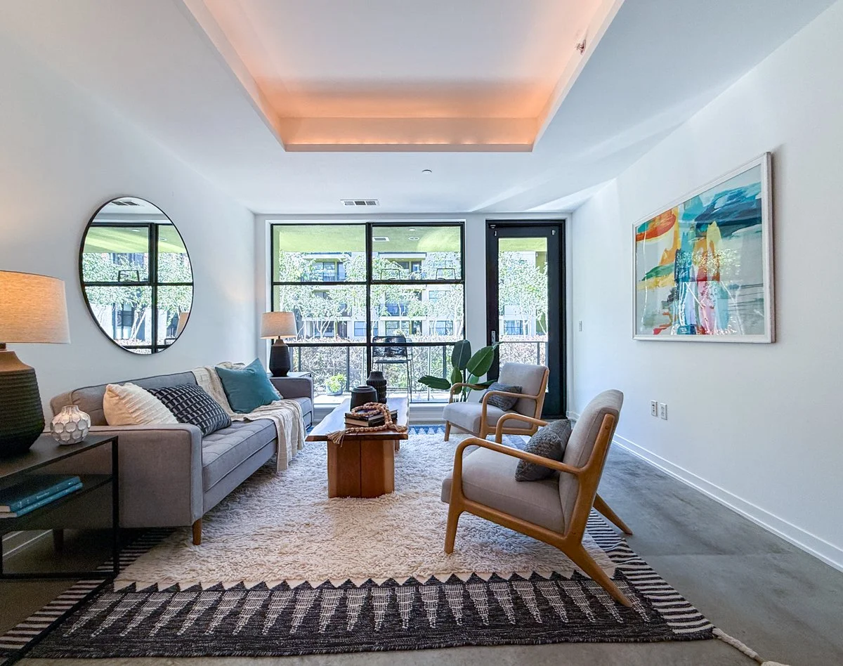 Living room with coffered ceiling, concrete floors. 