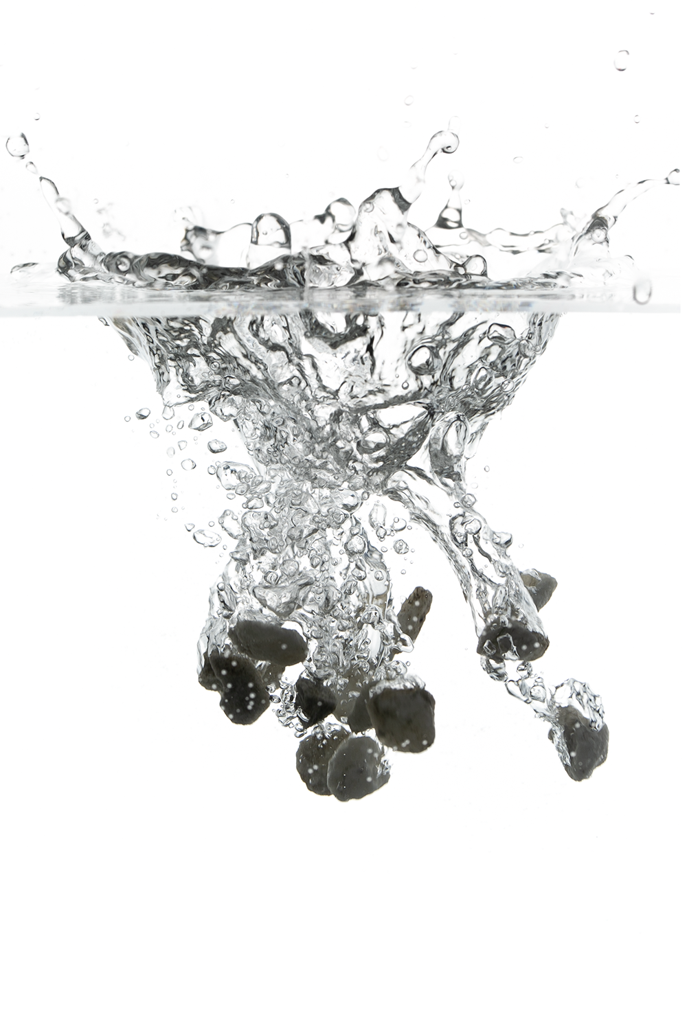 Blackberries being dropped into water creating a splash.