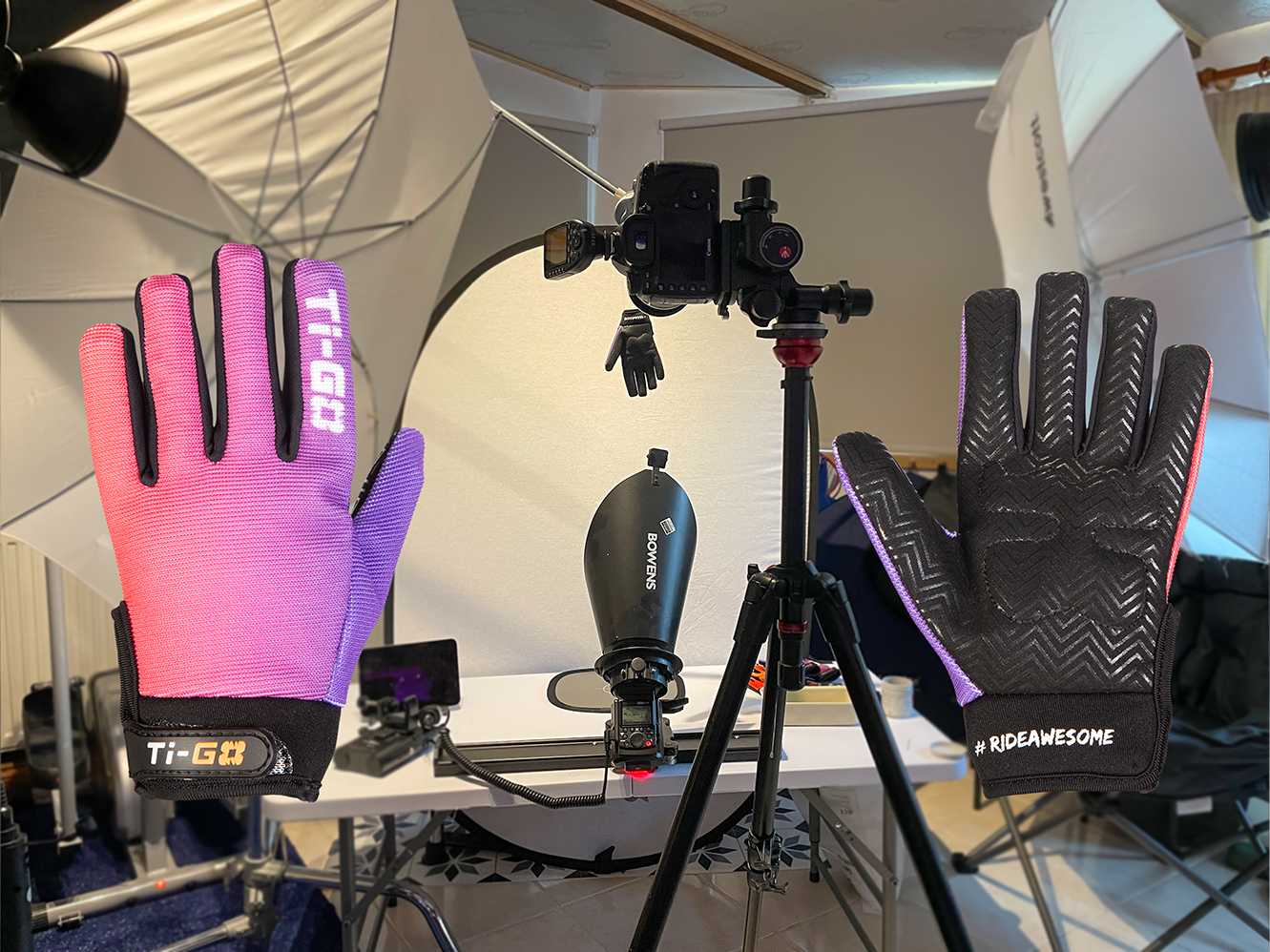 A photography setup with two gloves on a table, cameras, lighting, and other equipment, used for filming or photography.
