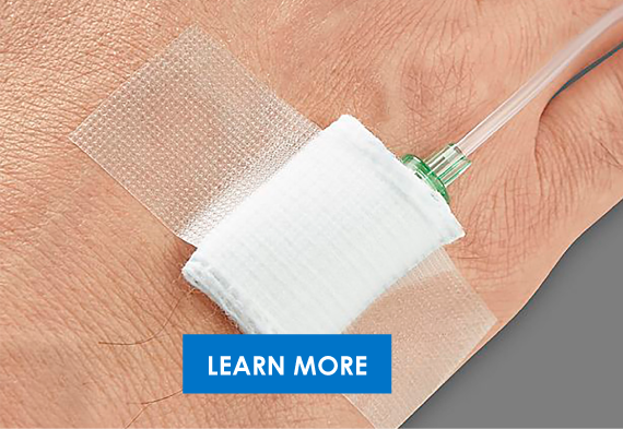 Close-up of a medical IV setup with a needle inserted into a patient's hand, secured with adhesive tape.