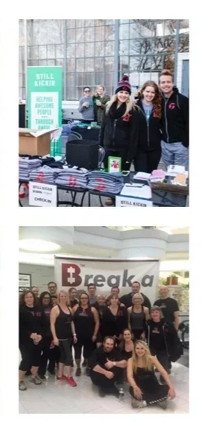 Group of people at a charity event, including volunteers and staff, indoors.