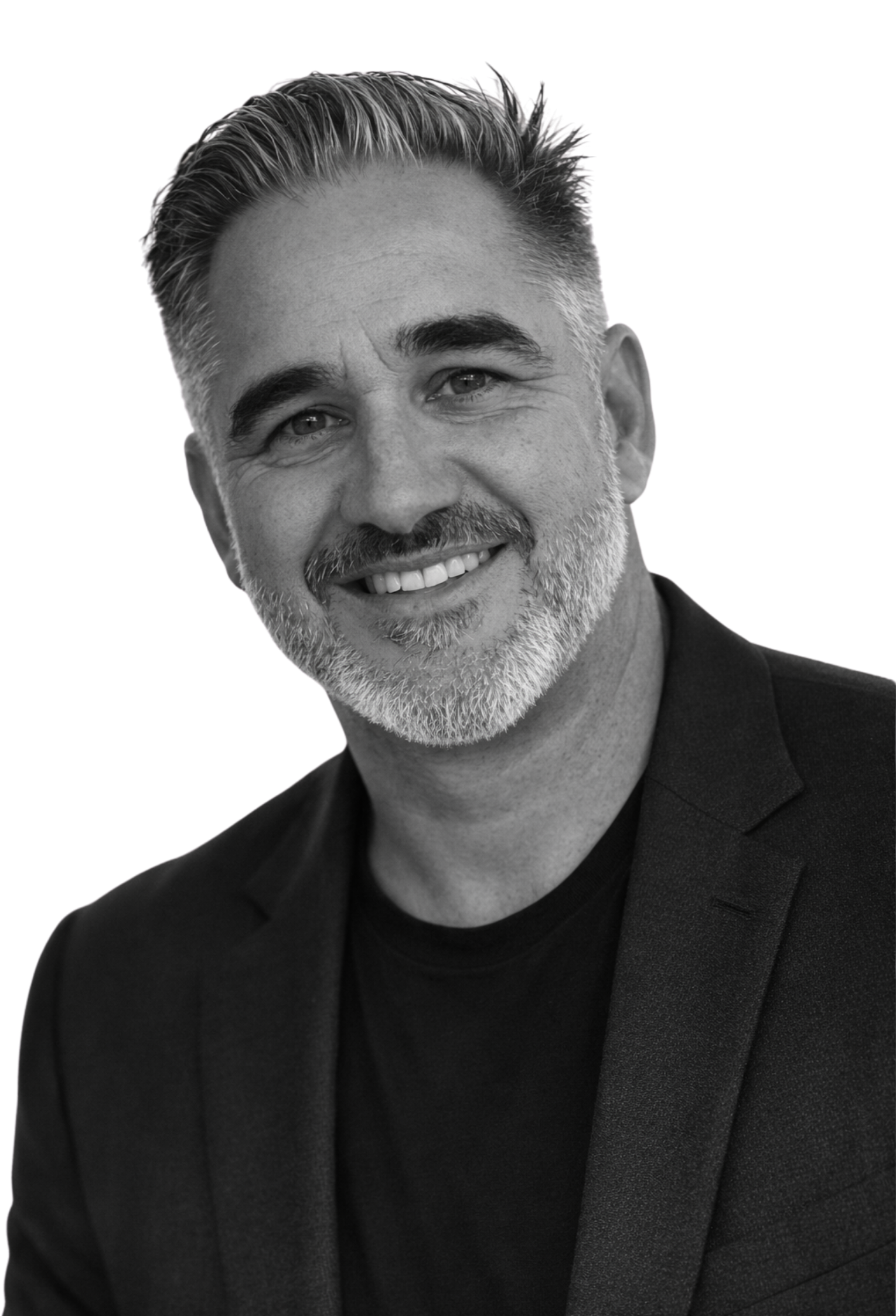 Black and white portrait of Samuel Carter wearing a dark blazer and T-shirt, indoors.