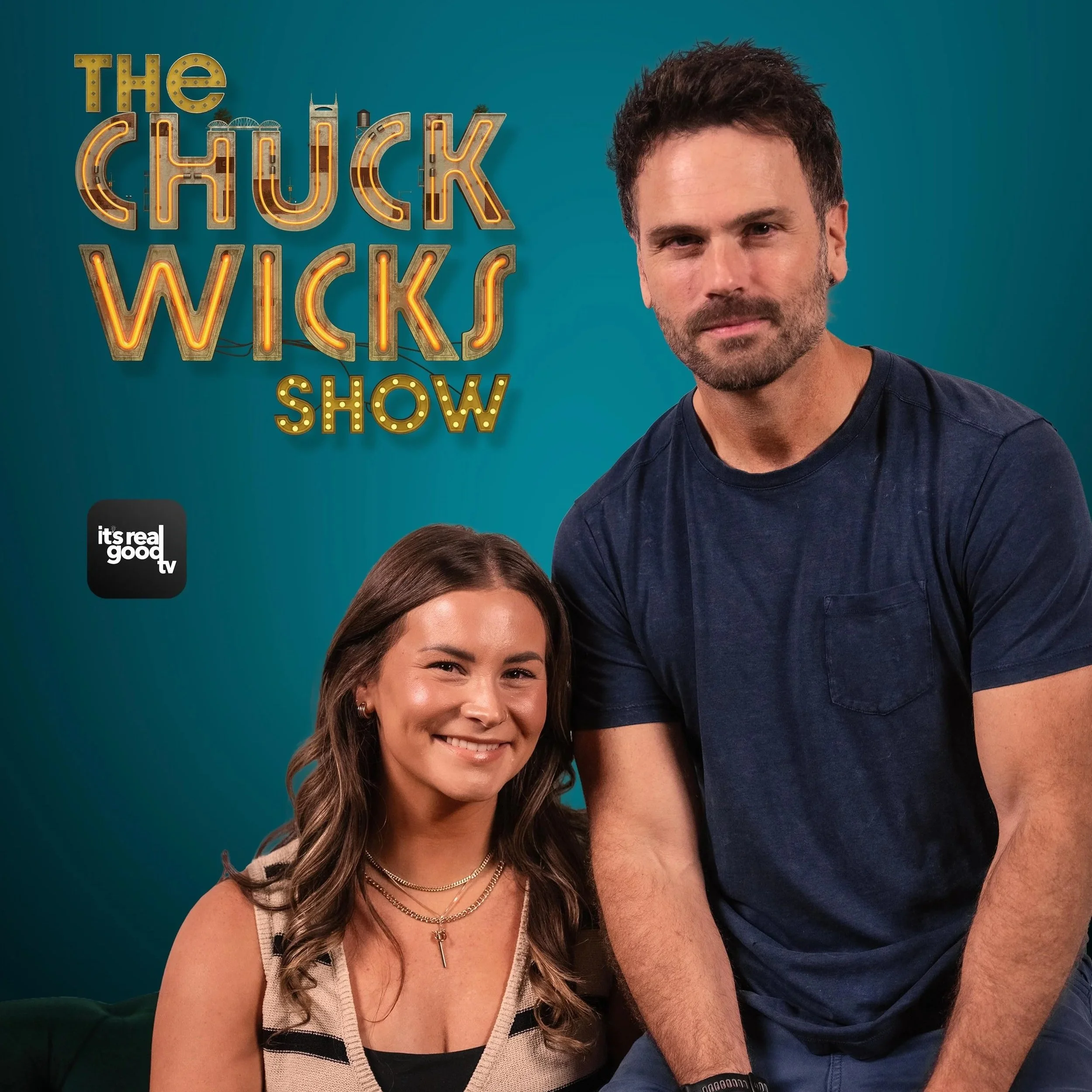 Image of a man and a woman smiling in front of a teal background with the text "The Chuck Wicks Show" illuminated in neon lights and a small black logo that says "it's real good tv."