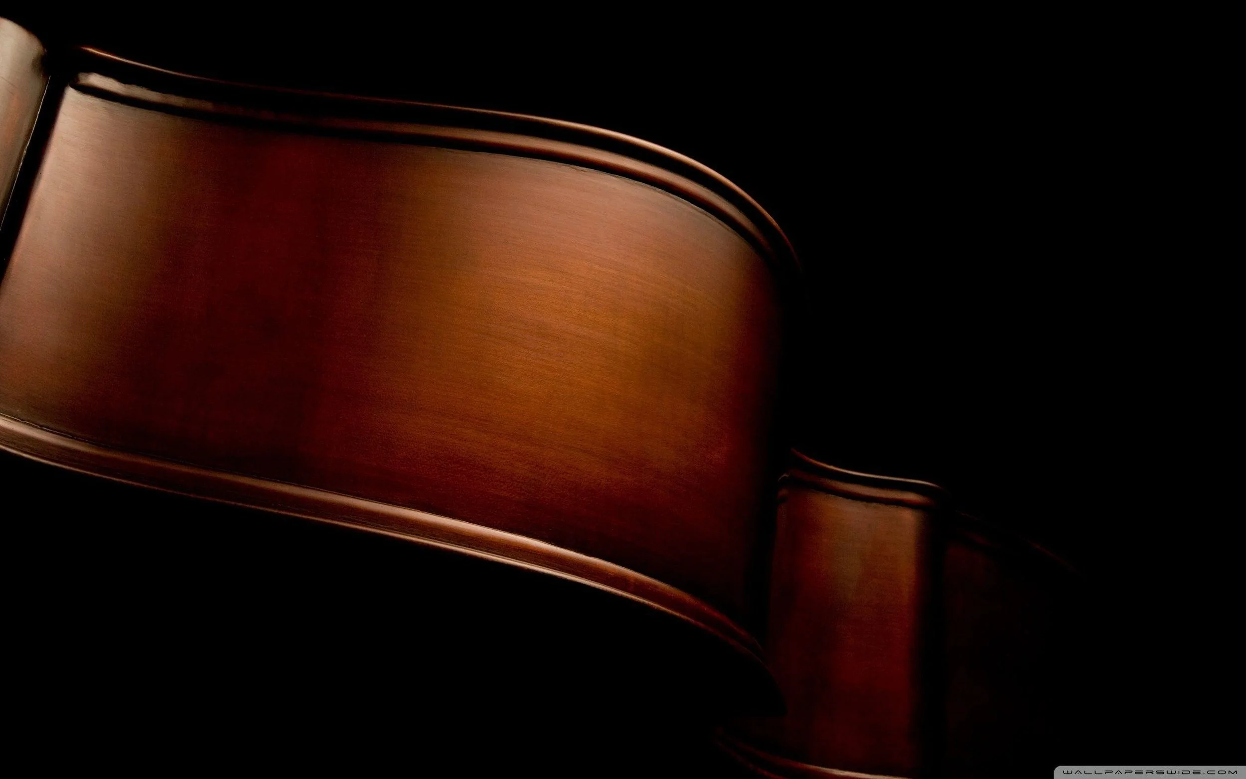 Close-up of a wooden piano with a dark background