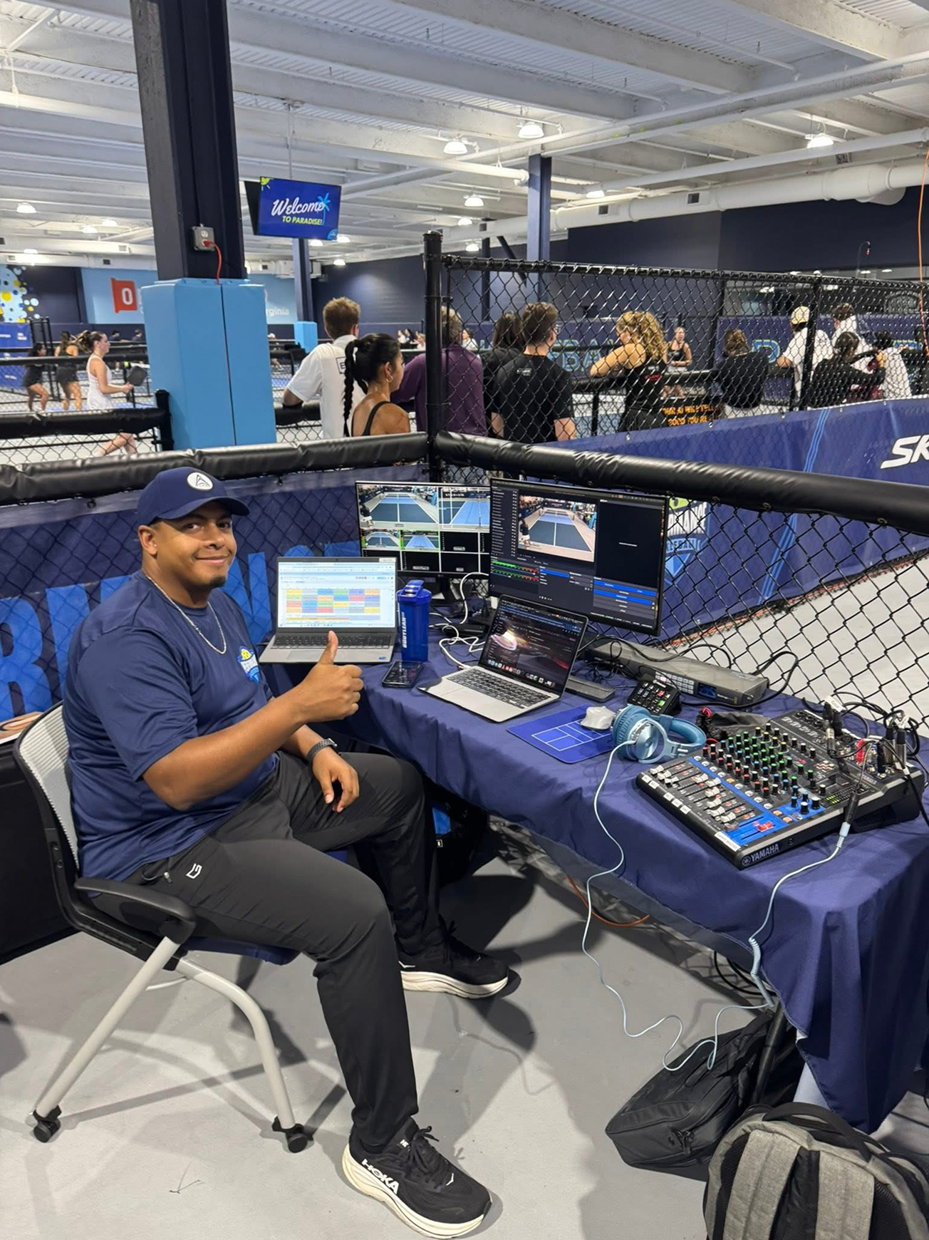 Performance Productions producer giving a thumbs up at the live stream production desk during a pickleball tournament