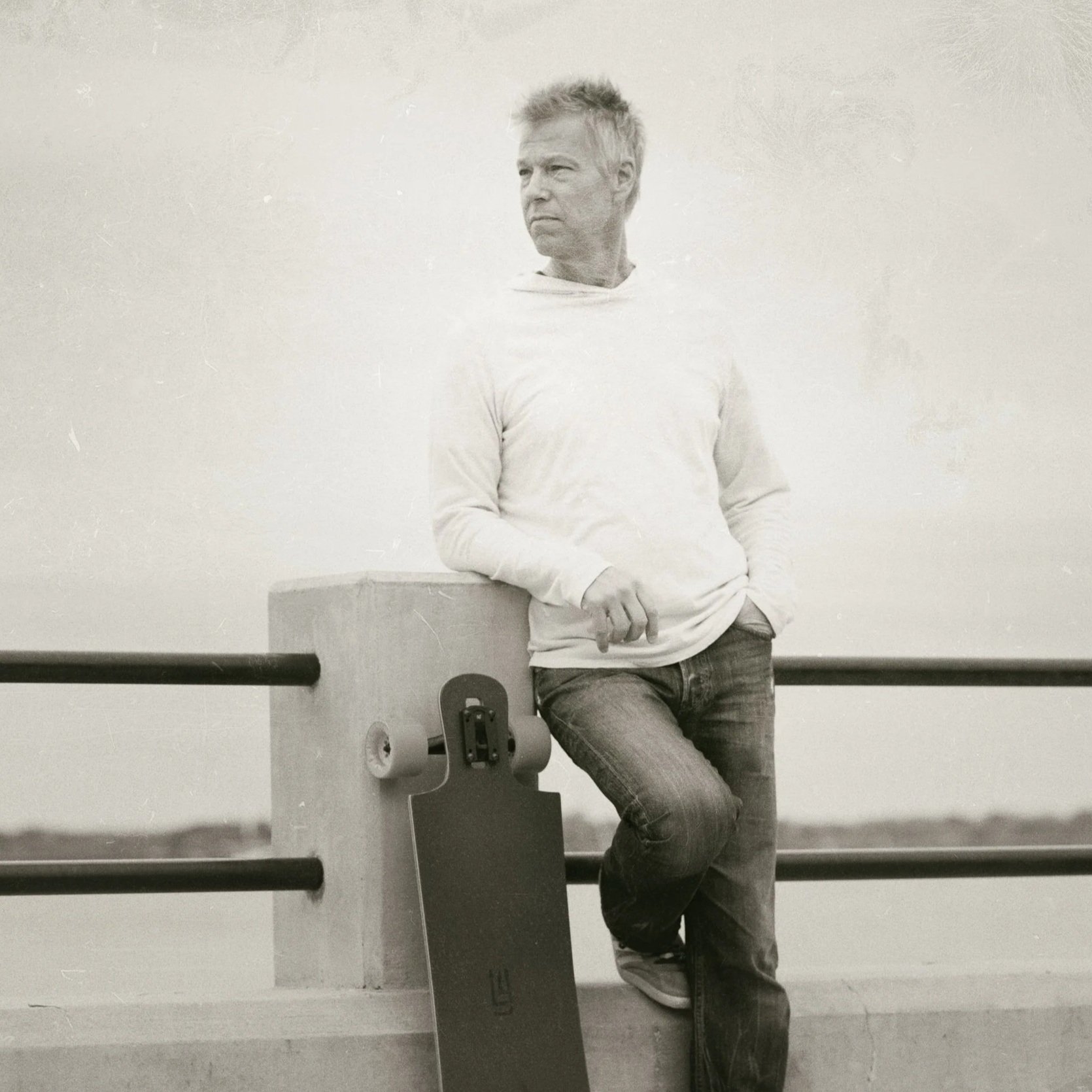 Kevin Holliday leaning against a concrete post at the Charleston battery, looking off into the distance.