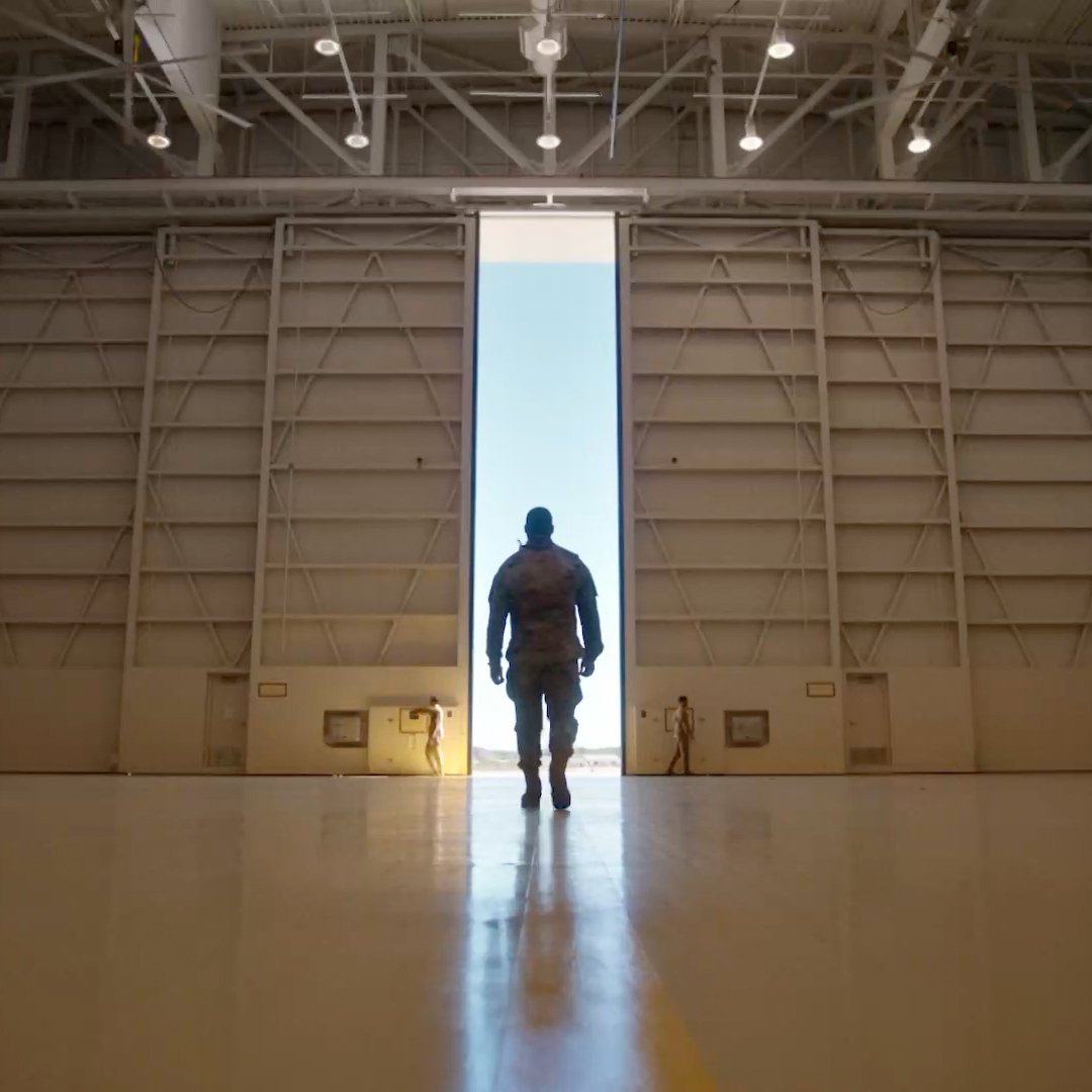 Soldier standing in hangar doorway