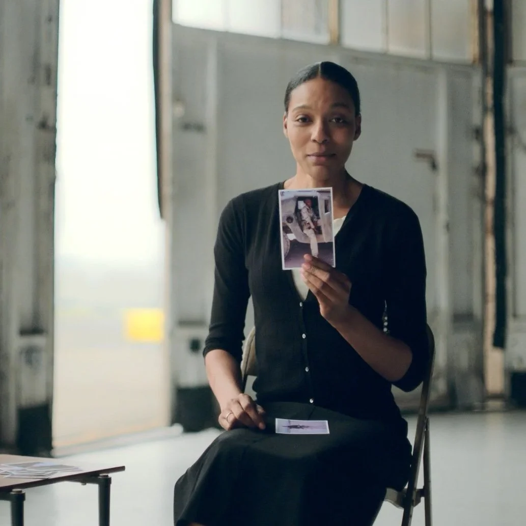 Woman holding photograph in interview setting