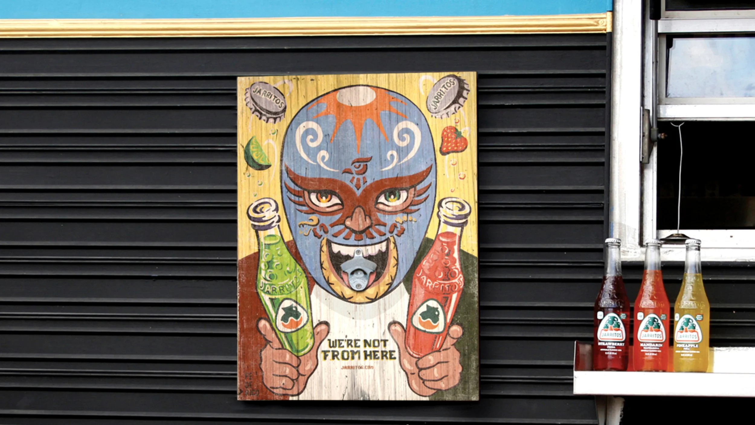 Jarritos branded promotional artwork displayed at a food service window
