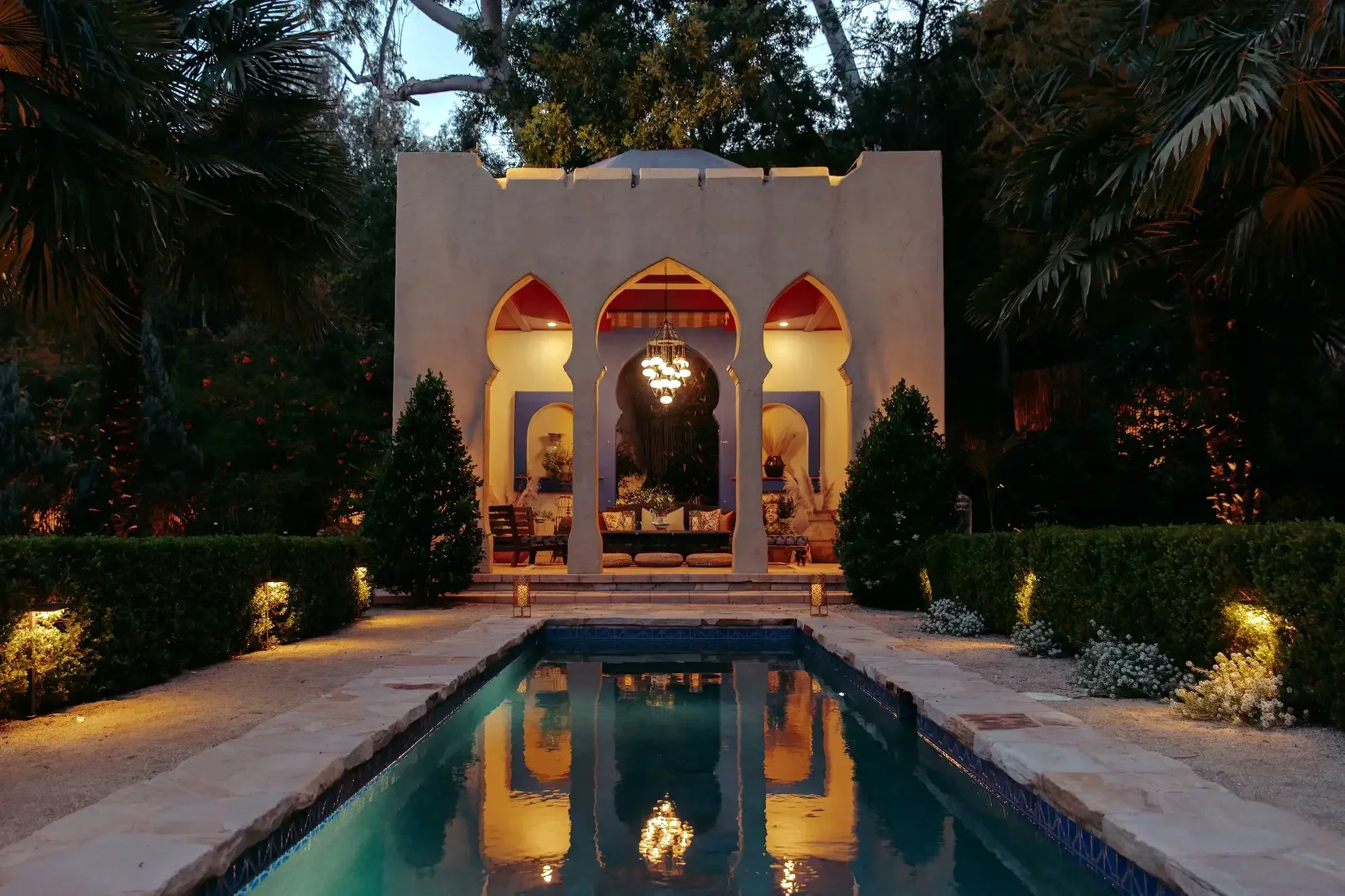 Elevated view of the Moroccan-inspired Kasbah, reflecting pool, fountains, and landscaped gardens  during golden hour at XOHH Events, a private production and filming location in the Hollywood Hills.